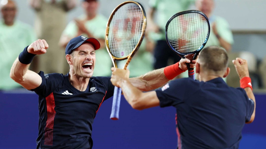 Andy Murray screaming and cheering alongside Dan Evans while holding their tennis rackets