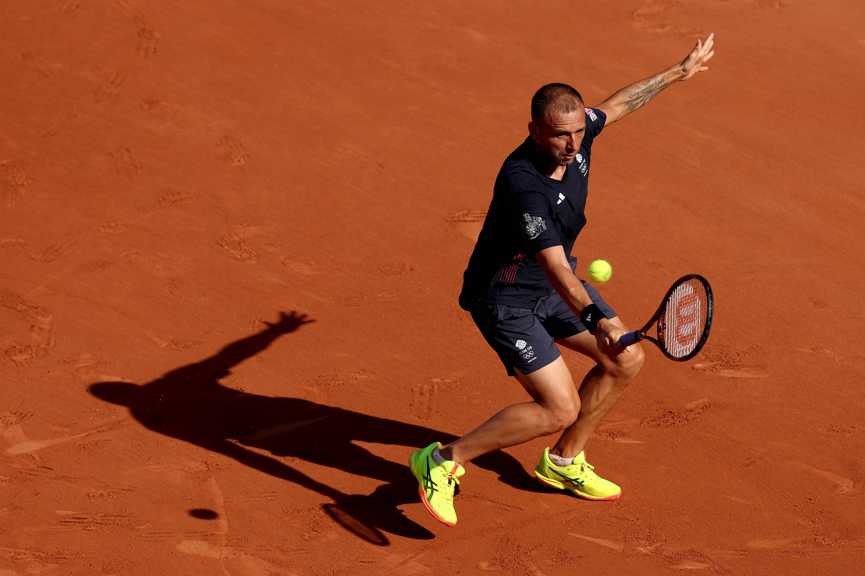 Dan Evans hits a backhand in the second round at the Olympics
