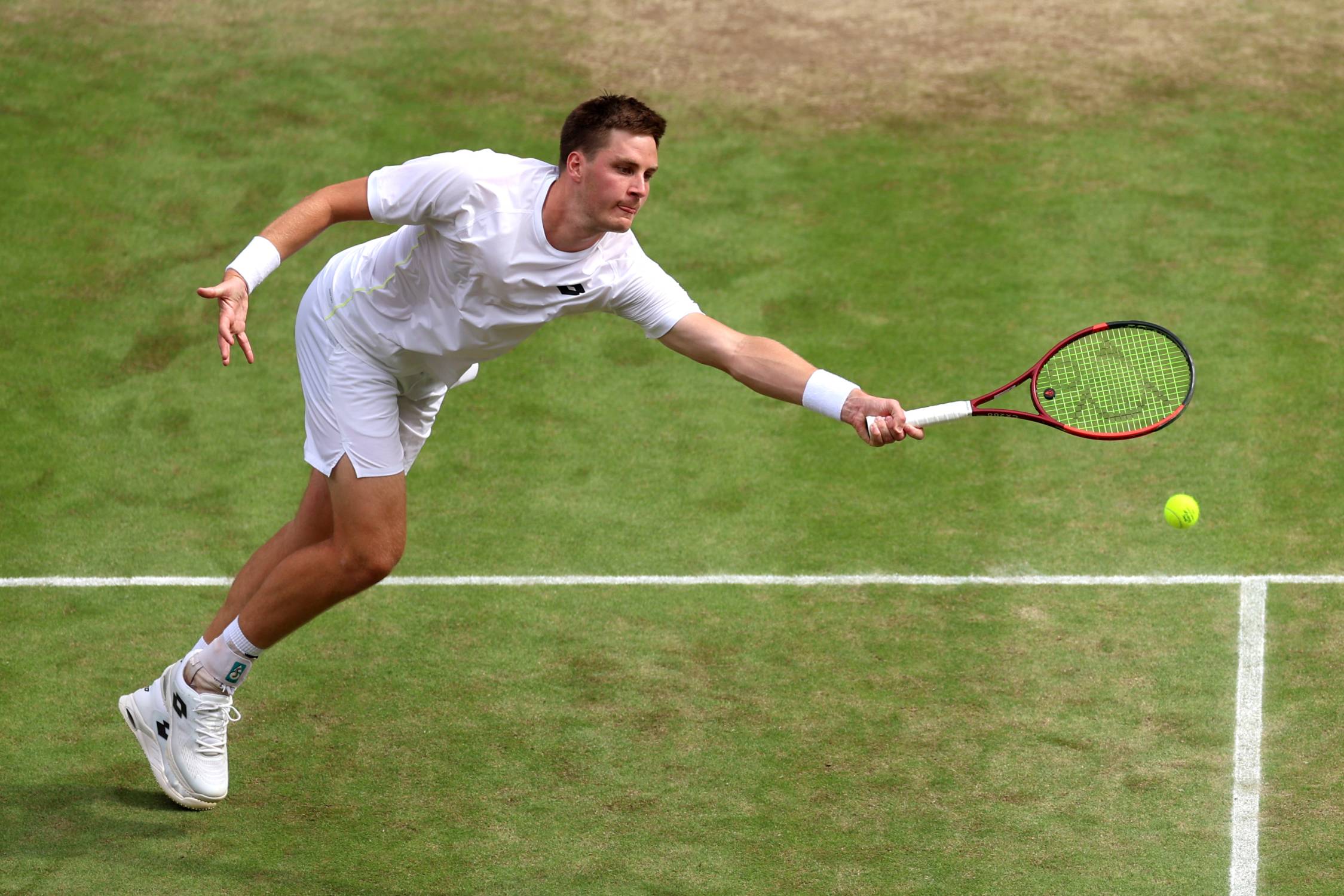 Henry Patten stretching for a forehand volley in the Wimbledon semi-finals