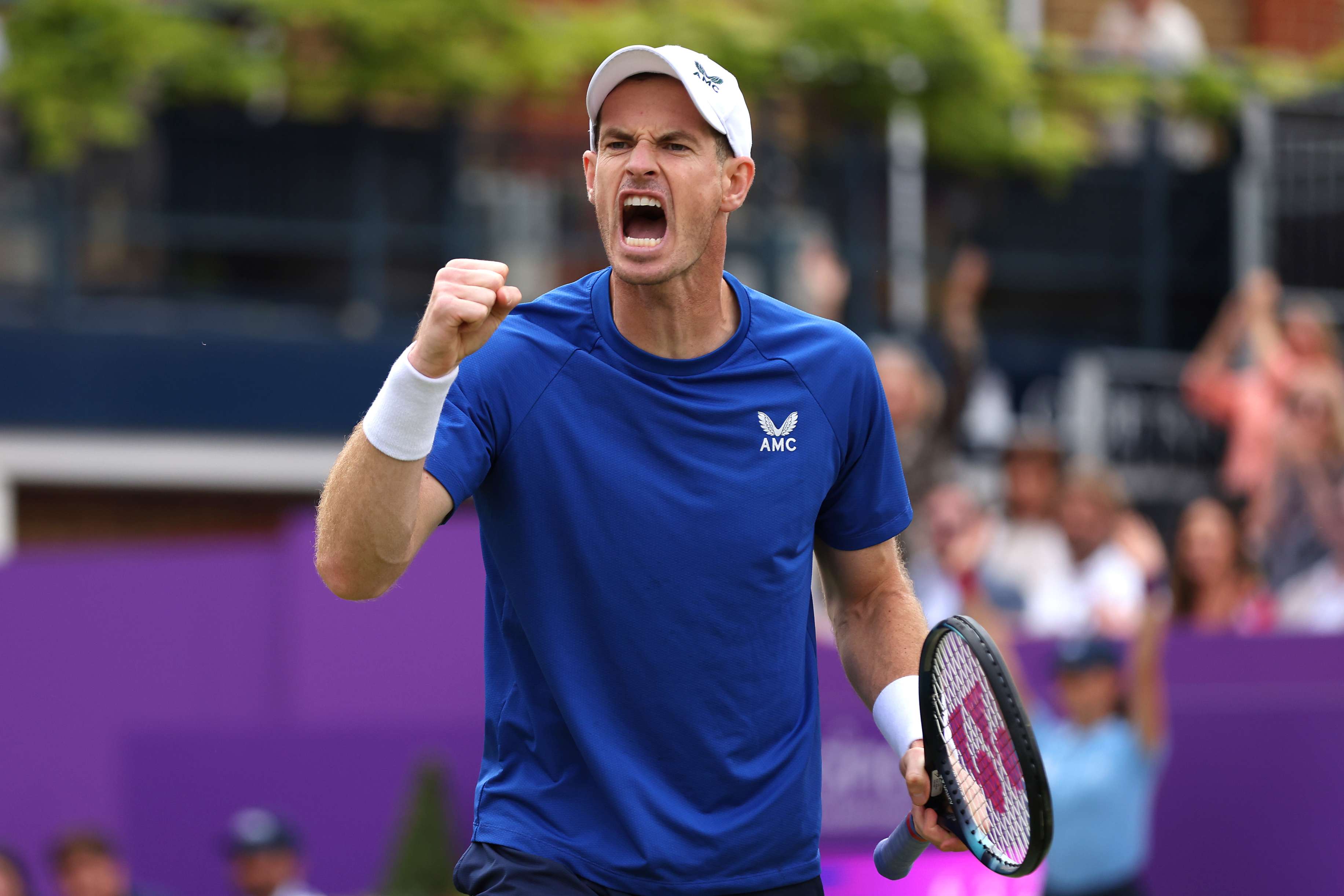 Andy Murray wearing a blue AMC kit while clenching his fist and cheering at the cinch Championships