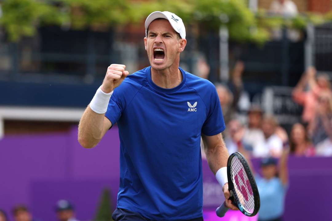 Andy Murray wearing a blue AMC kit while clenching his fist and cheering at the cinch Championships