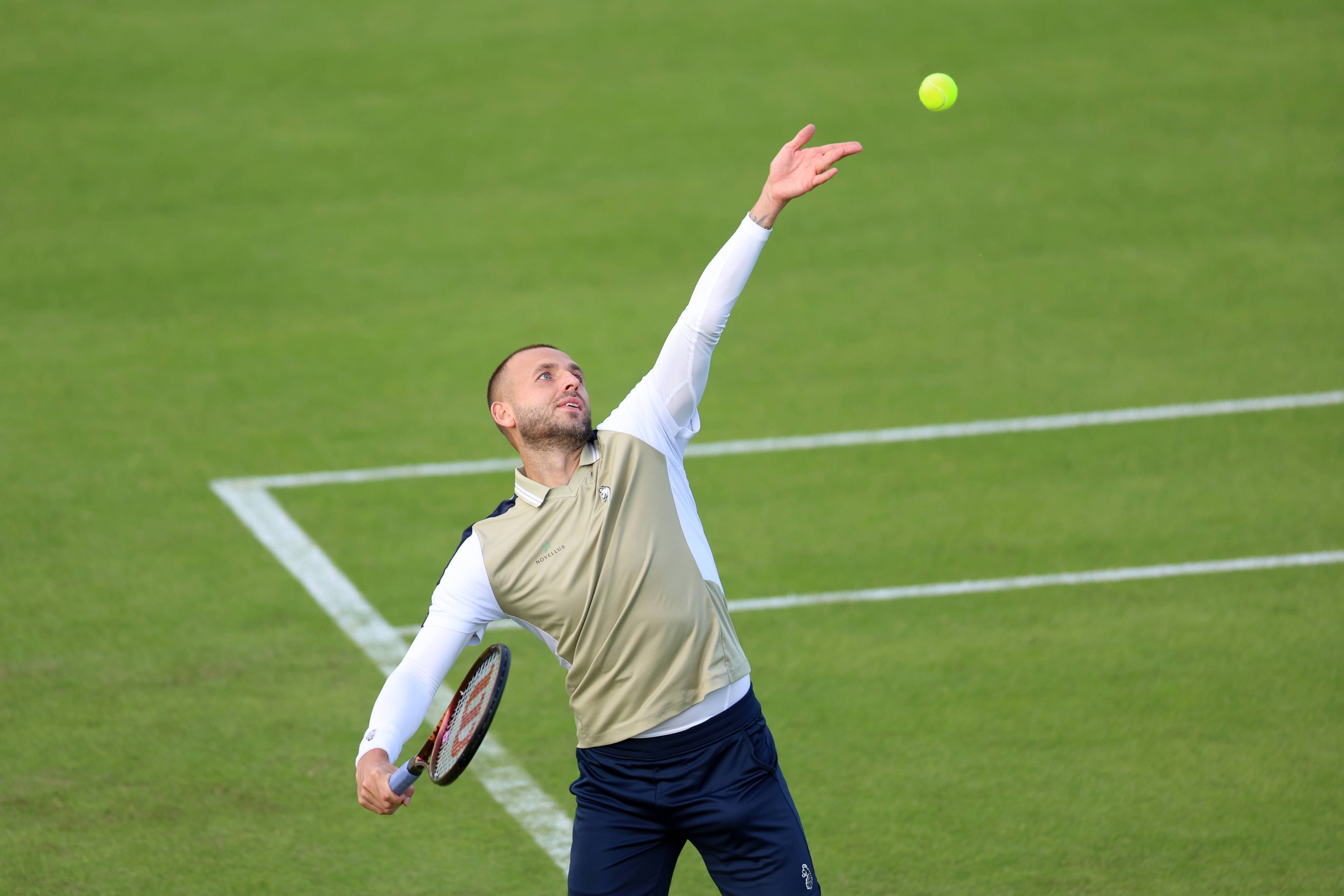 Dan Evans serves at the Rothesay Open Nottingham