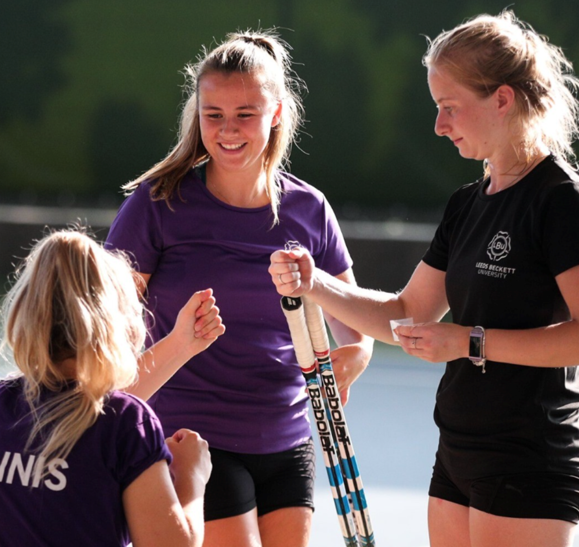University tennis players fist bumping