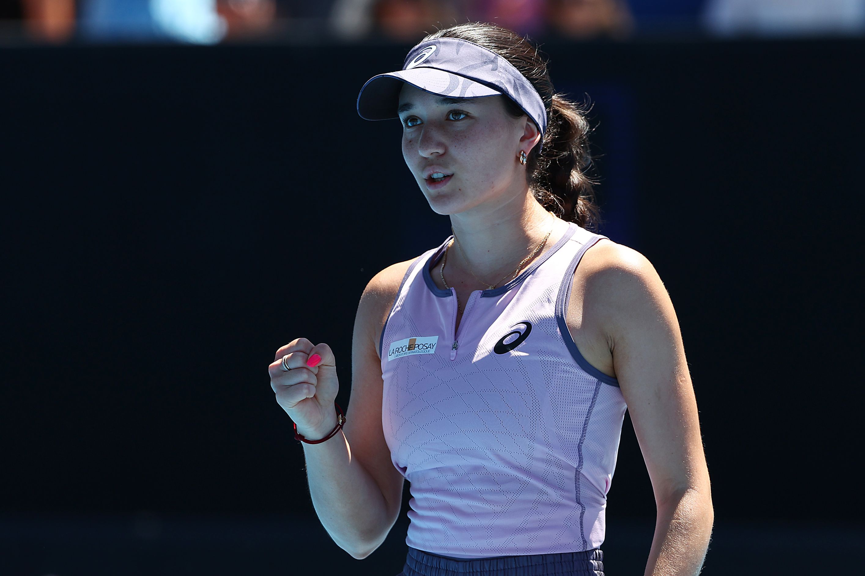 German tennis player Eva Lys clinches her fist in celebration while on court at the Australian Open