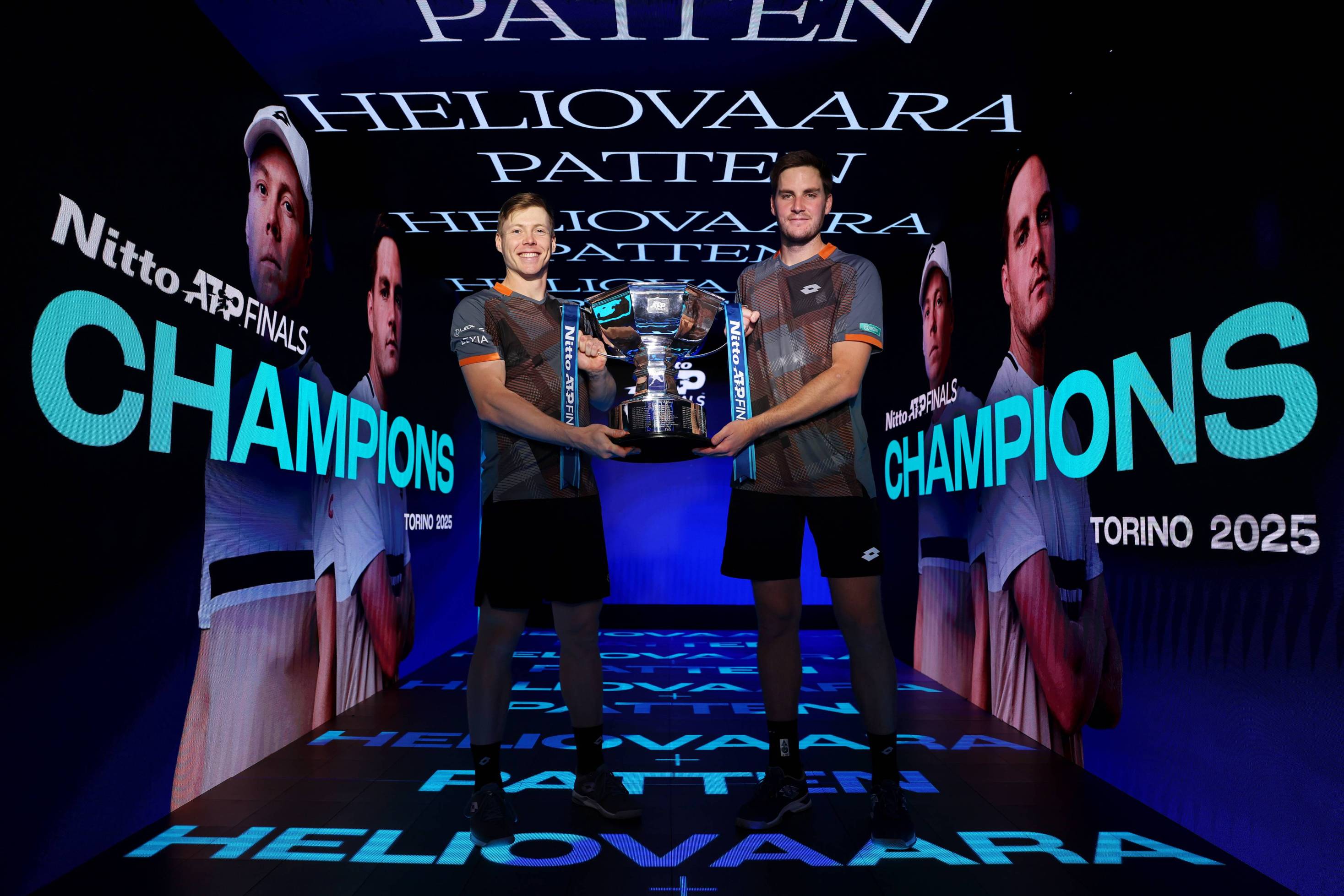 Harri Heliovaara and Henry Patten holding the 2025 Nitto ATP Finals doubles title