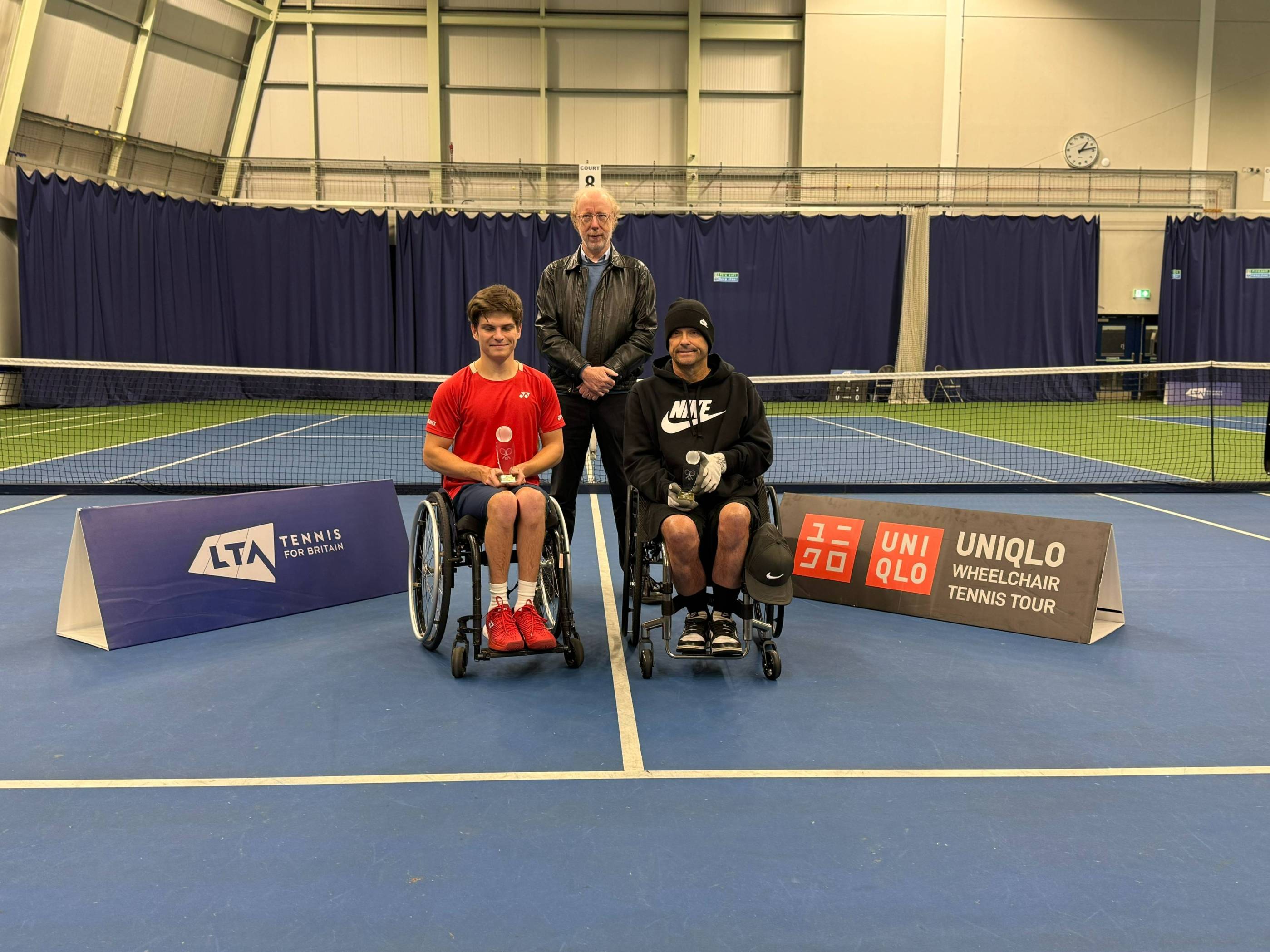 Greg Slade holding the doubles runner-up trophy at the Bolton Indoor ITF 2
