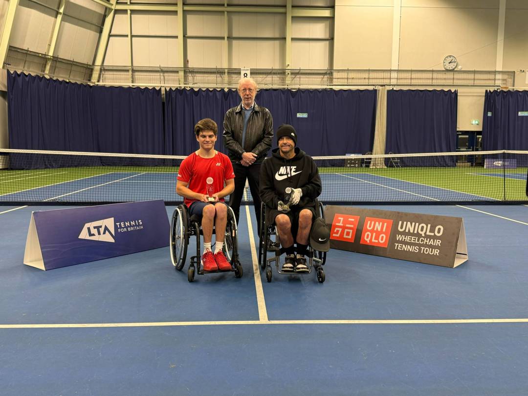 Greg Slade holding the doubles runner-up trophy at the Bolton Indoor ITF 2