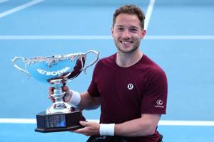 Alfie Hewett holding the 2025 Australian Open men's singles title