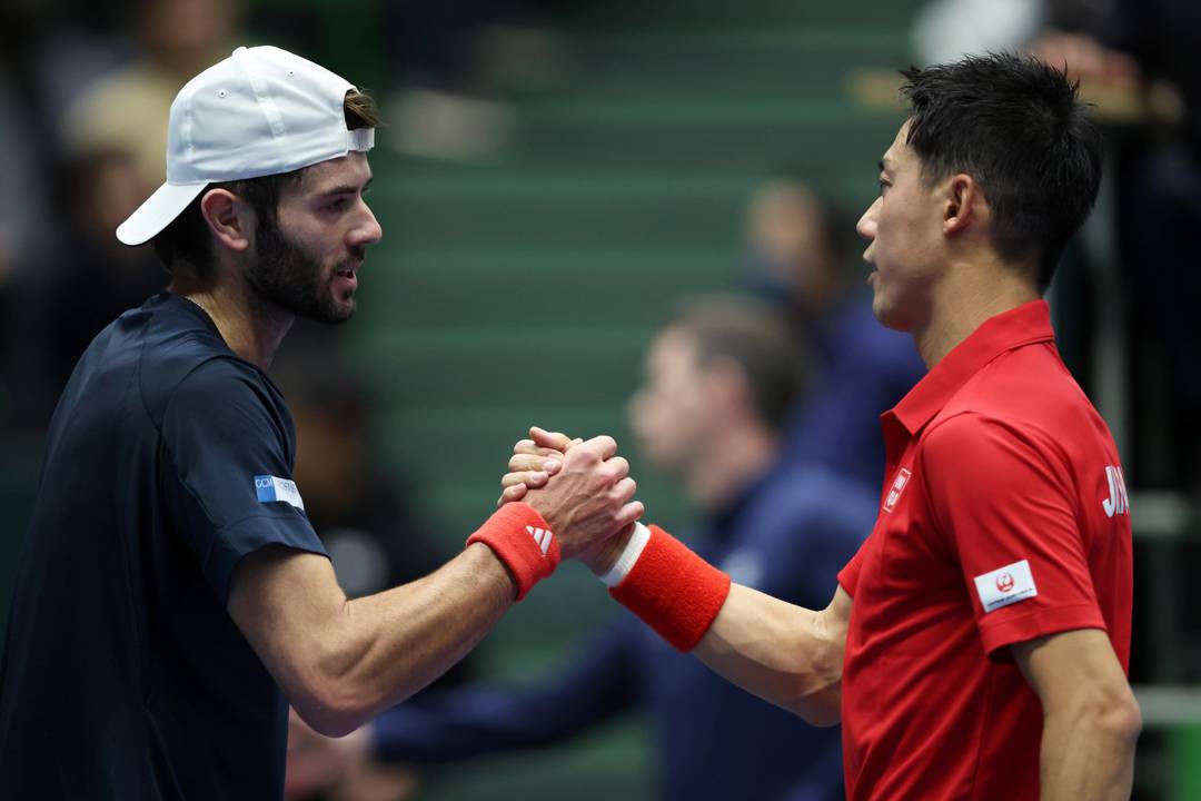 Jacob Fearnley and Kei Nishikori shake hands at the Davis Cup