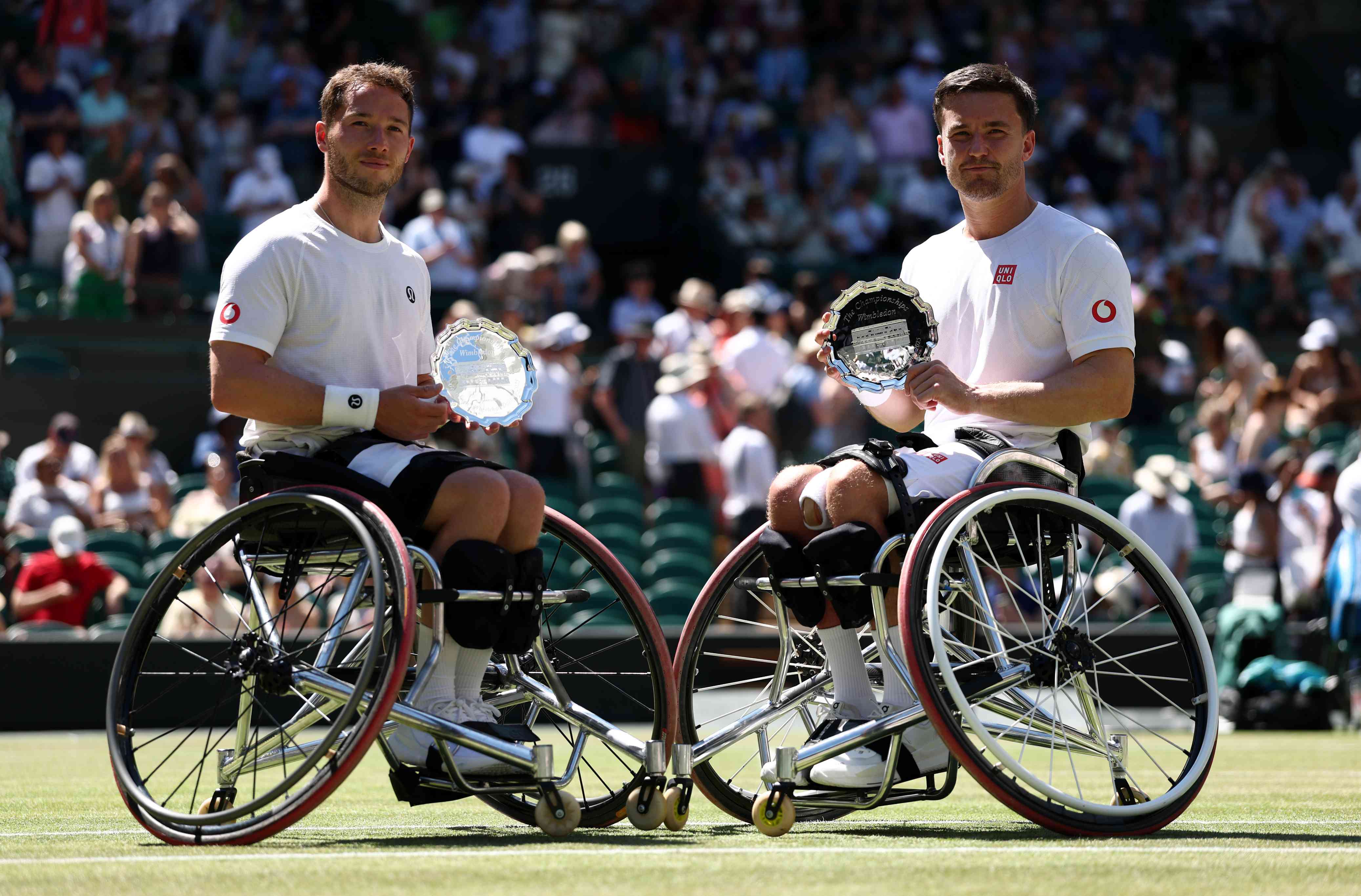 Alfie Hewett and Gordon Reid smiling with their Wimbleodn  men's wheelchairdoubles runner-up trophies