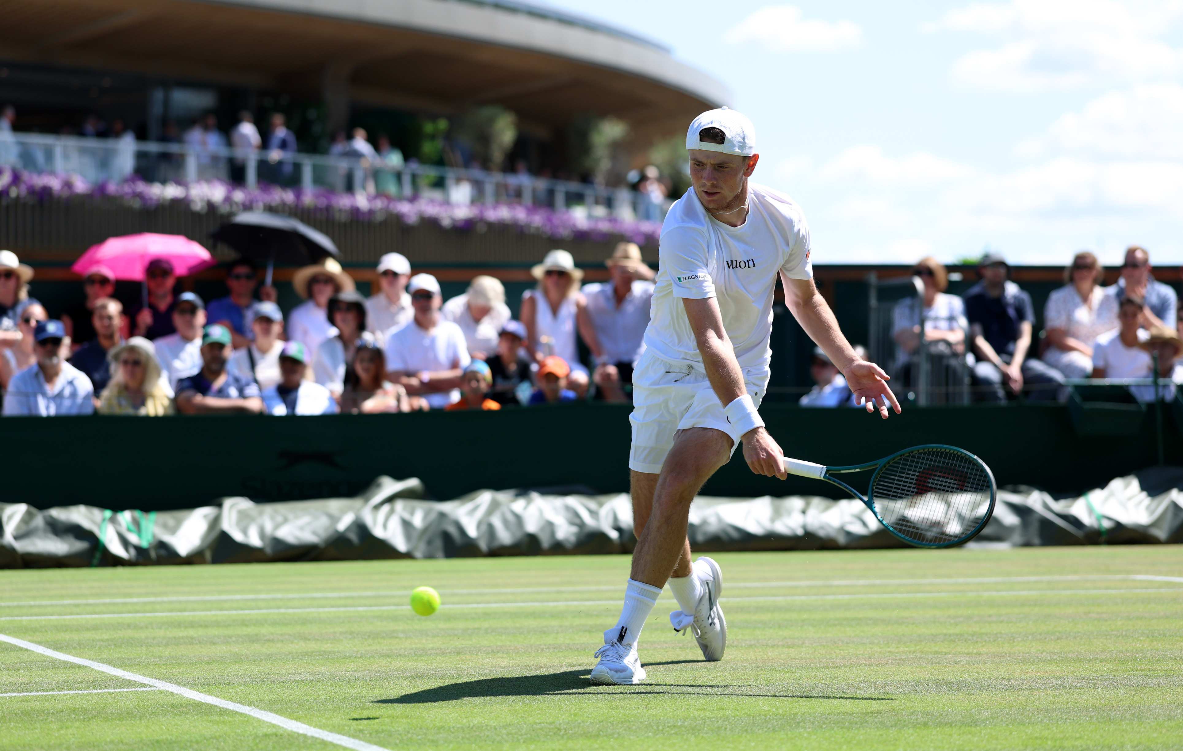 Jack Pinnington Jones hitting a backhand on court at Wimbledon