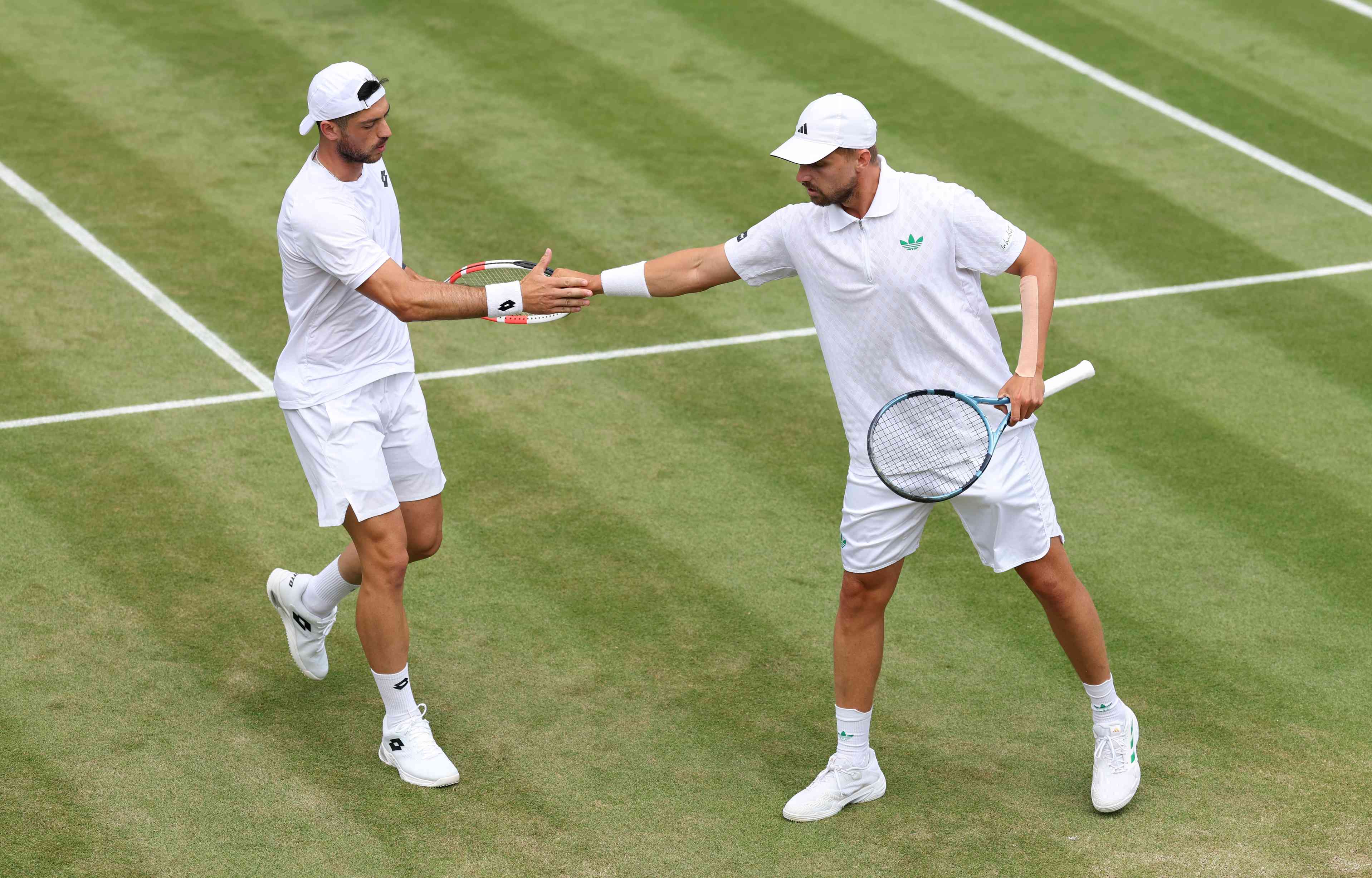 Julian Cash and Lloyd Glasspool high five in the third round at Wimbledon