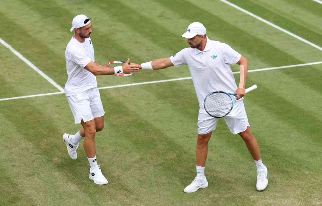 Julian Cash and Lloyd Glasspool high five in the third round at Wimbledon