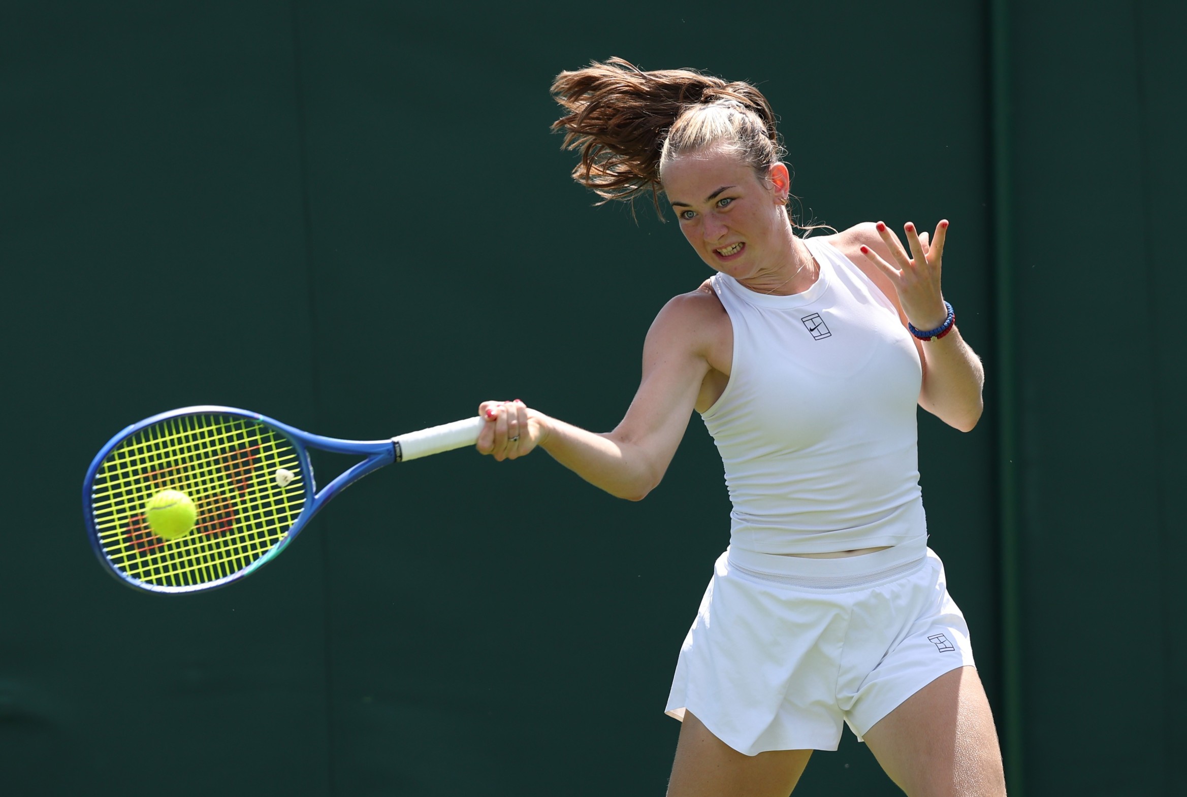 Mika Stojsavljevic hitting a forehand on court at the Championships at Wimbledon, having received a wild card to the main draw