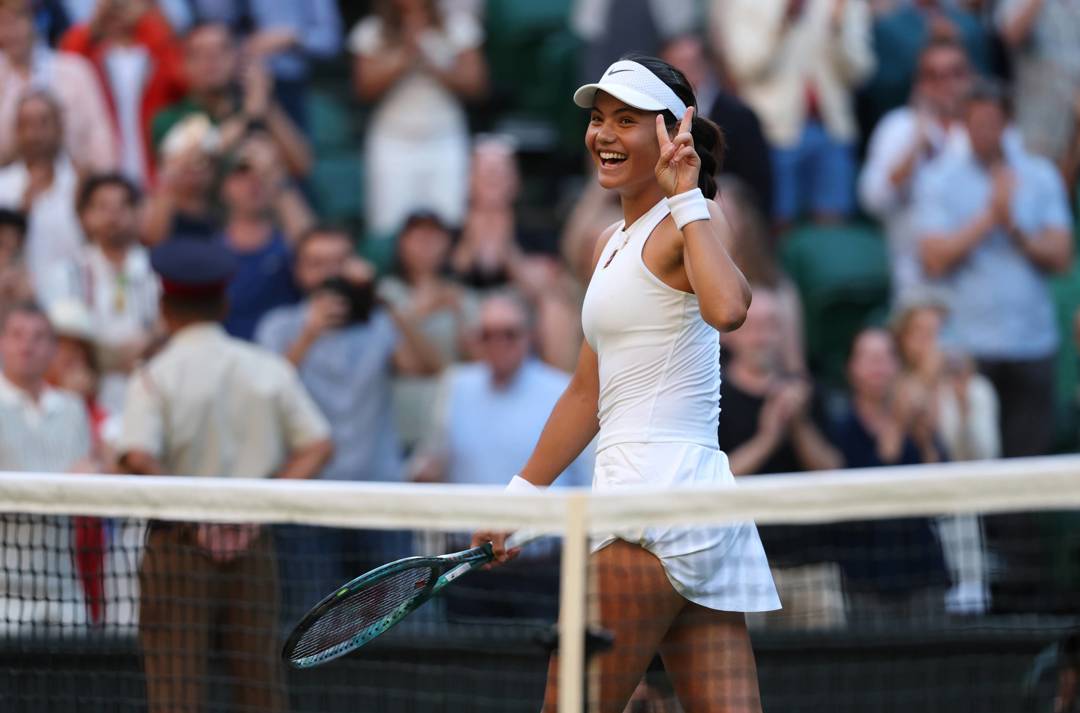 Emma Raducanu holds up the peace sign after a second round win at Wimbledon 2025