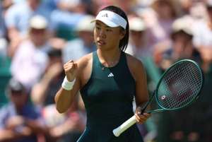 British tennis player, Mimi Xu clenching her fist on court at the Lexus Nottingham Open while holding her tennis racket in her other hand 