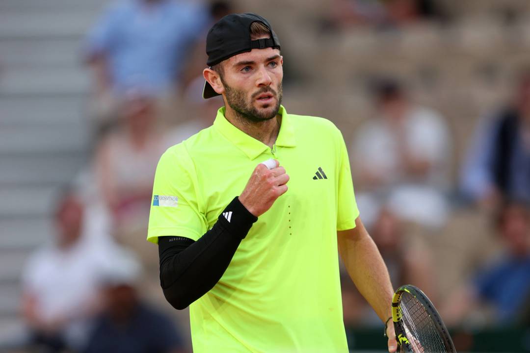 Jacob Fearnley pumps his fist in celebration during his second round match at Roland Garros
