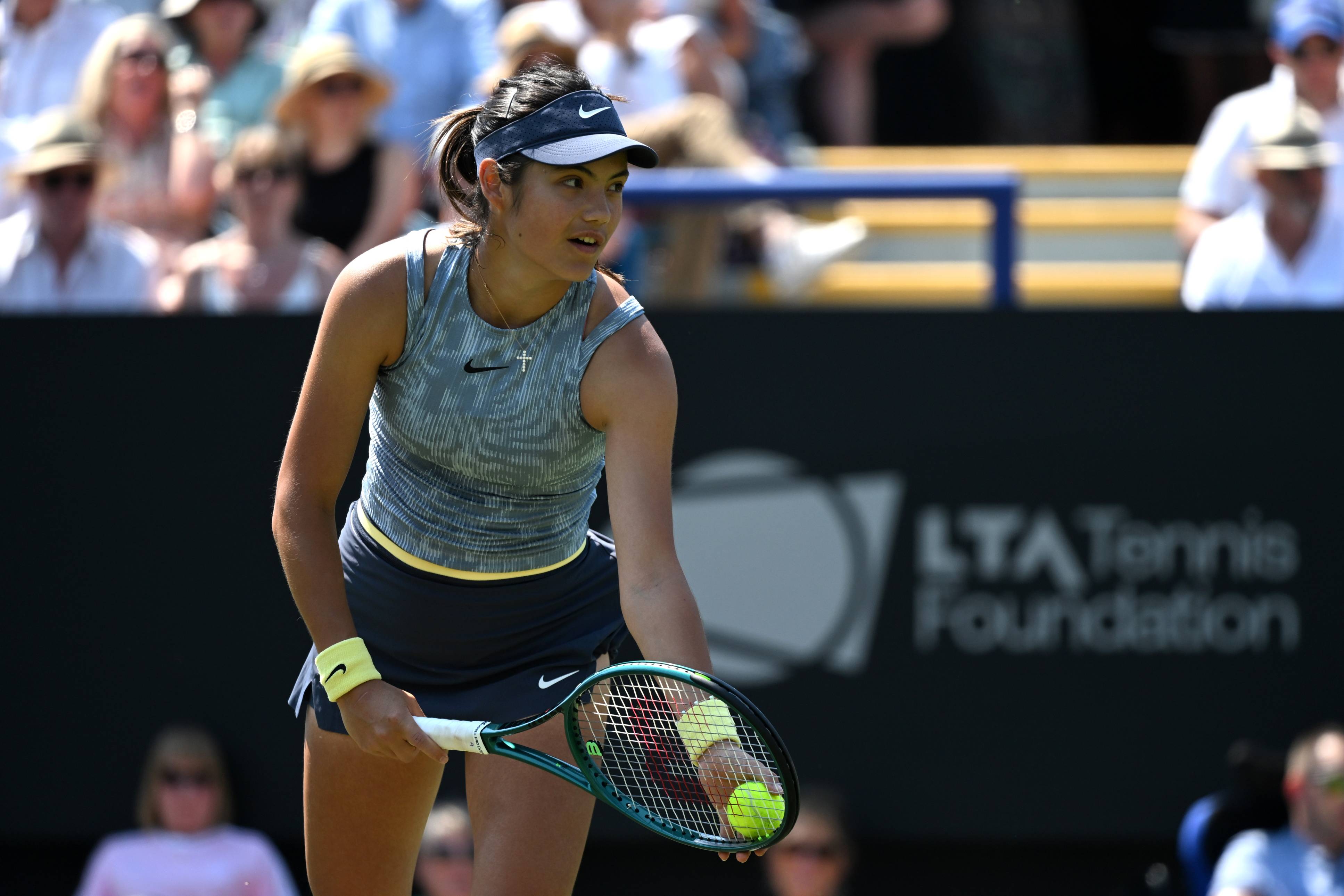 Emma Raducanu lines up a serve in action at Eastbourne