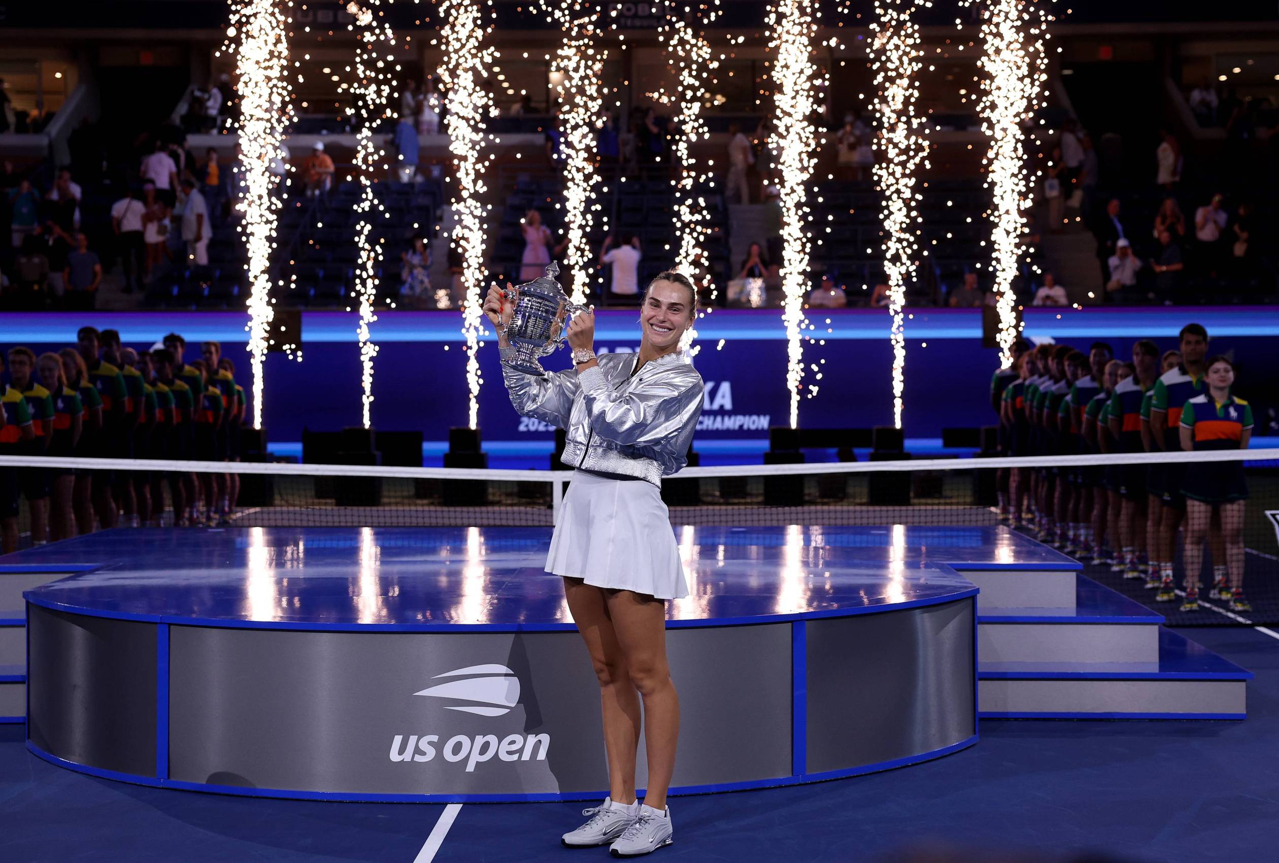 Aryna Sabalenka holding the 2025 US Open women's singles trophy