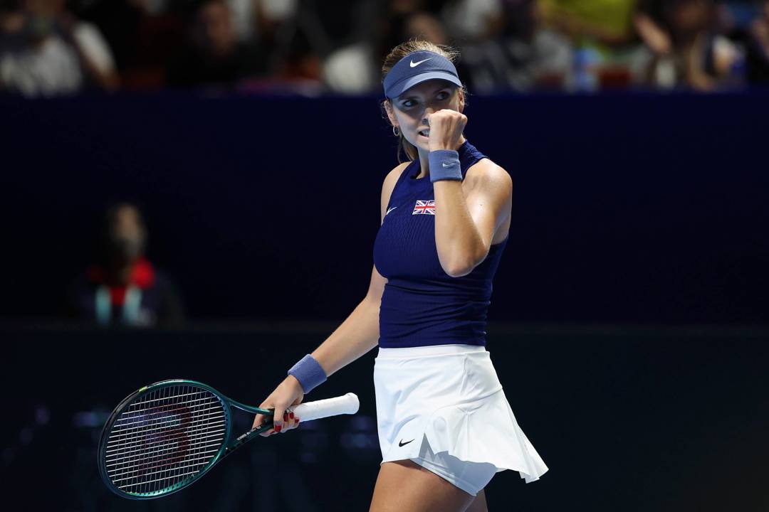 British tennis player Katie Boulter clenching her fist on court after winning a point during Great Britain's Billie Jean King Cup tie against Japan