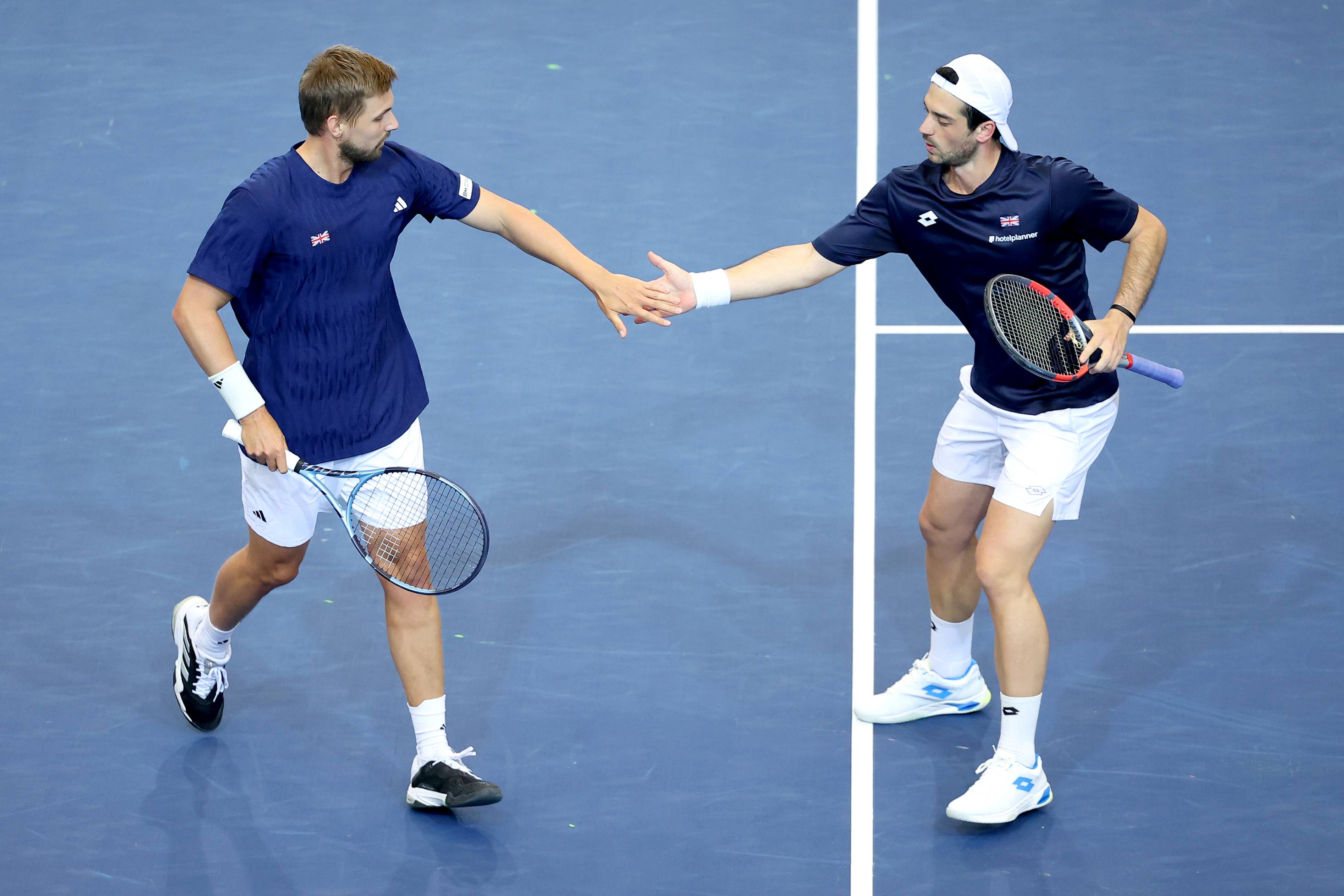 Lloyd Glasspool and Julian Cash high five during Davis Cup action against Norway