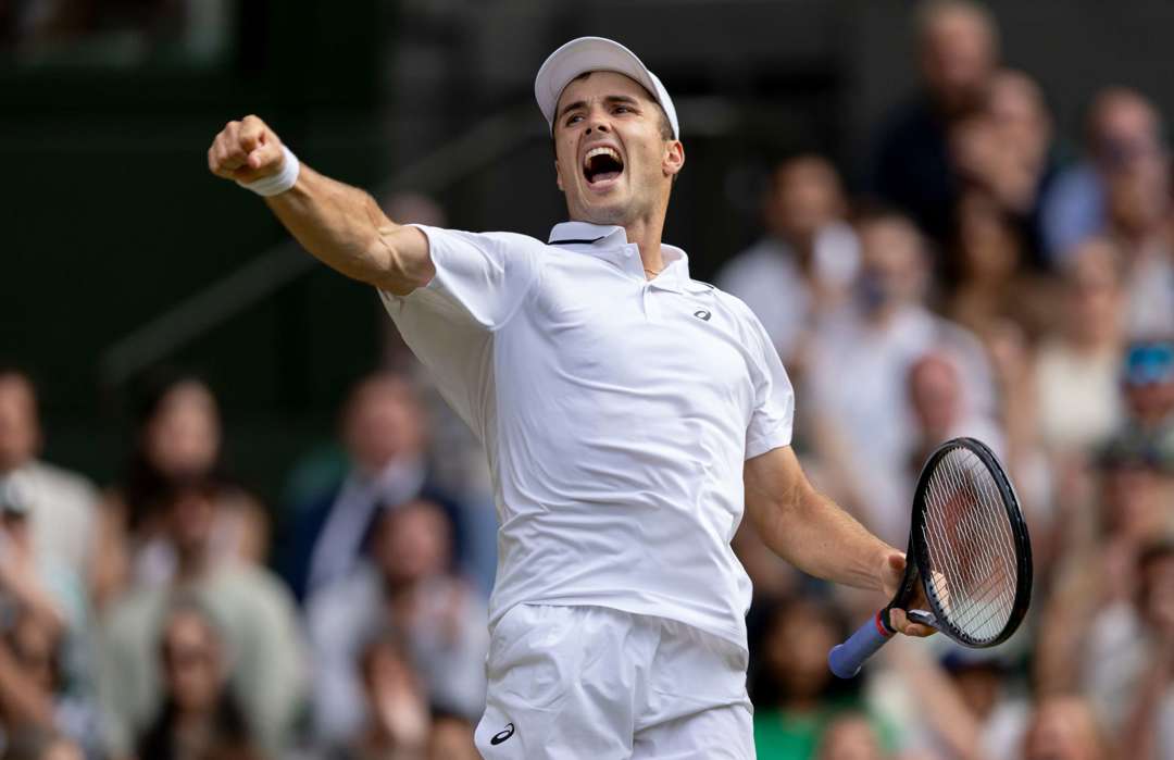 Fery cheering and raising his fit in celebration after his fourth round win on Wimbledon Centre Court