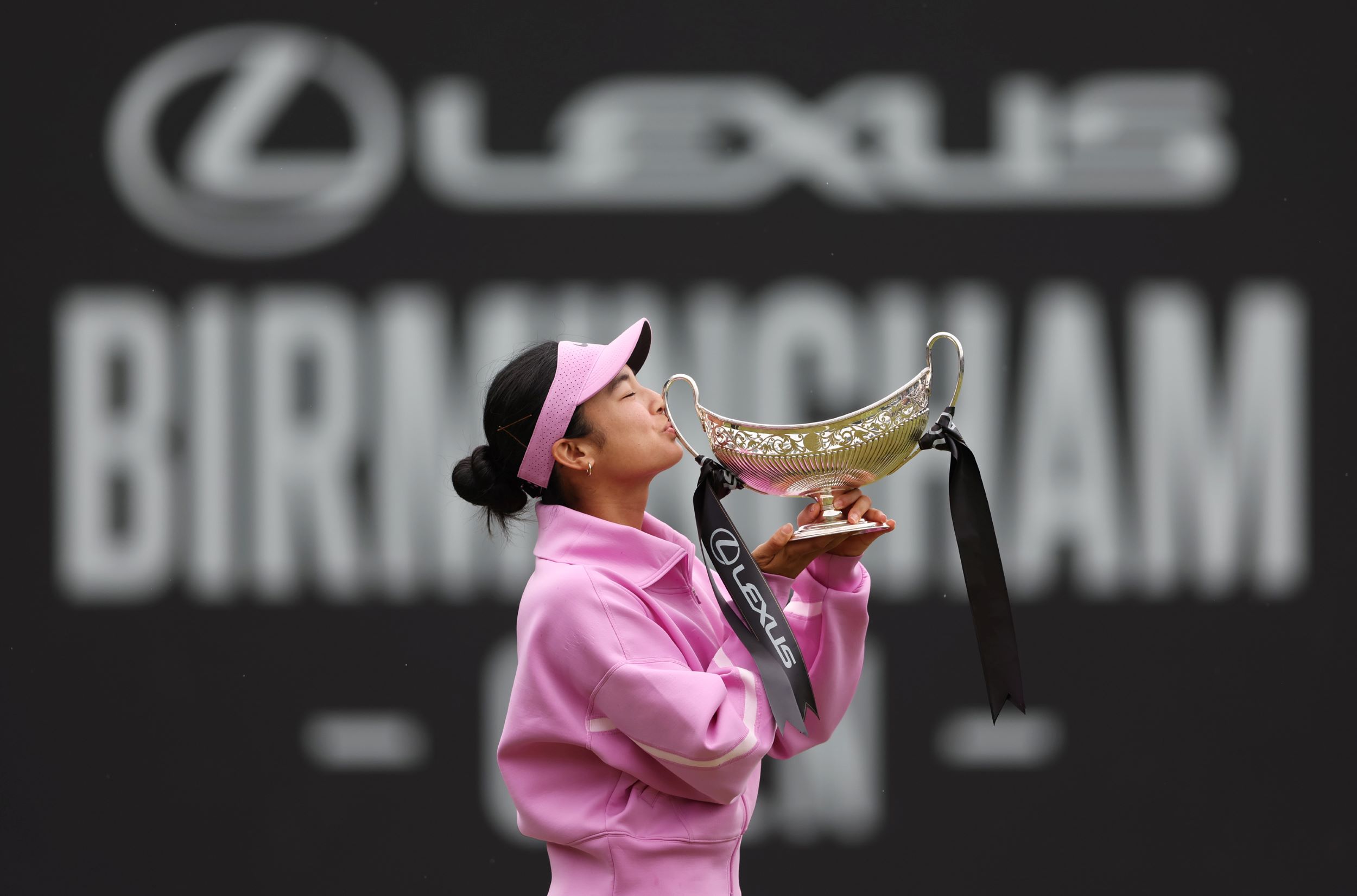 Tennis player Alexandra Eala kissing the trophy after her win at the Lexus Birmingham Open