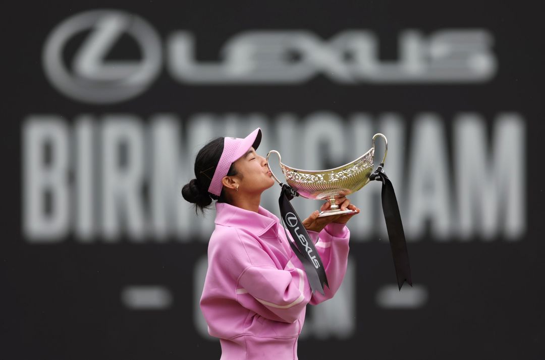 Tennis player Alexandra Eala kissing the trophy after her win at the Lexus Birmingham Open