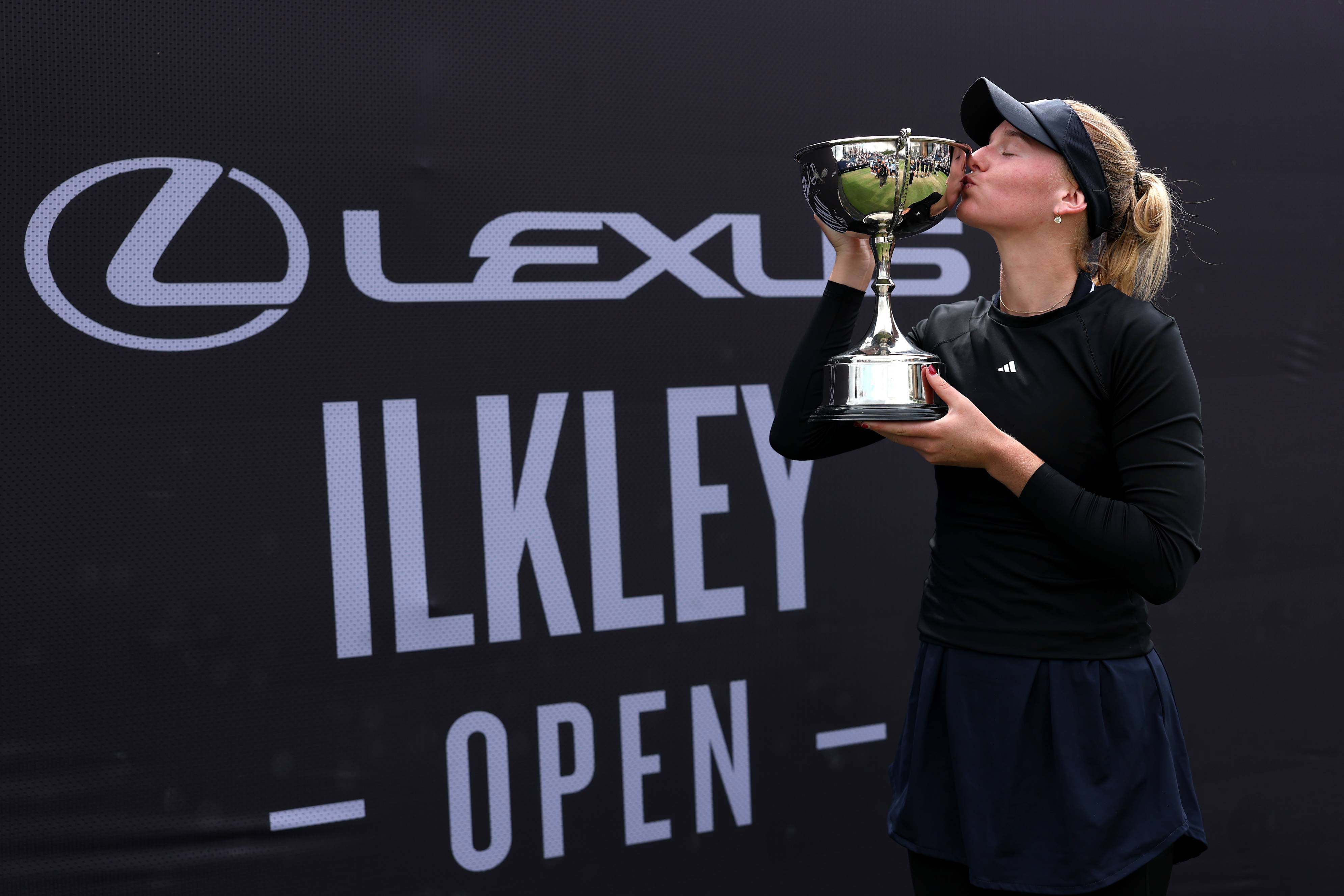 American tennis player Ashlyn Krueger kissing the Lexus Ilkley Open trophy after winning the women's singles title 