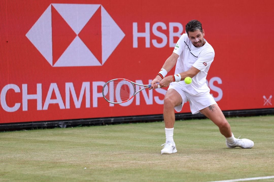 Cam Norrie bending down to hit a backhand on court at the HSBC Championships