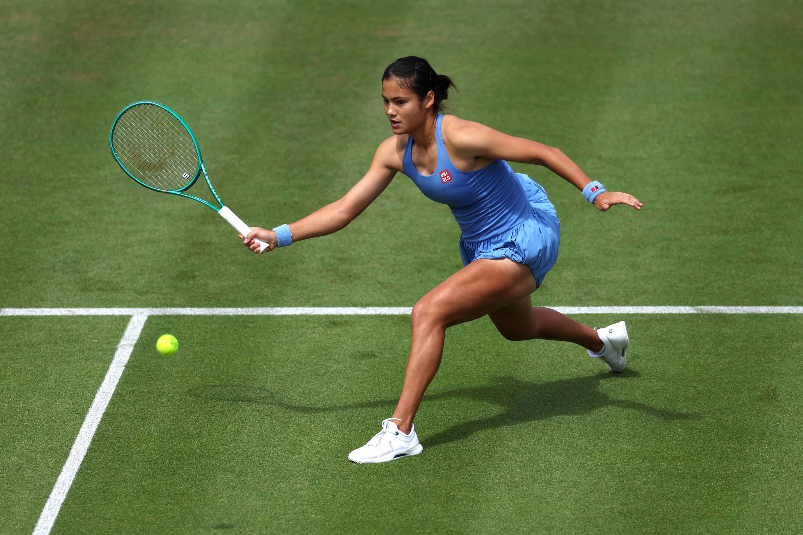 Emma Raducanu lunges forward to hit a forehand in the first round of the HSBC Championships