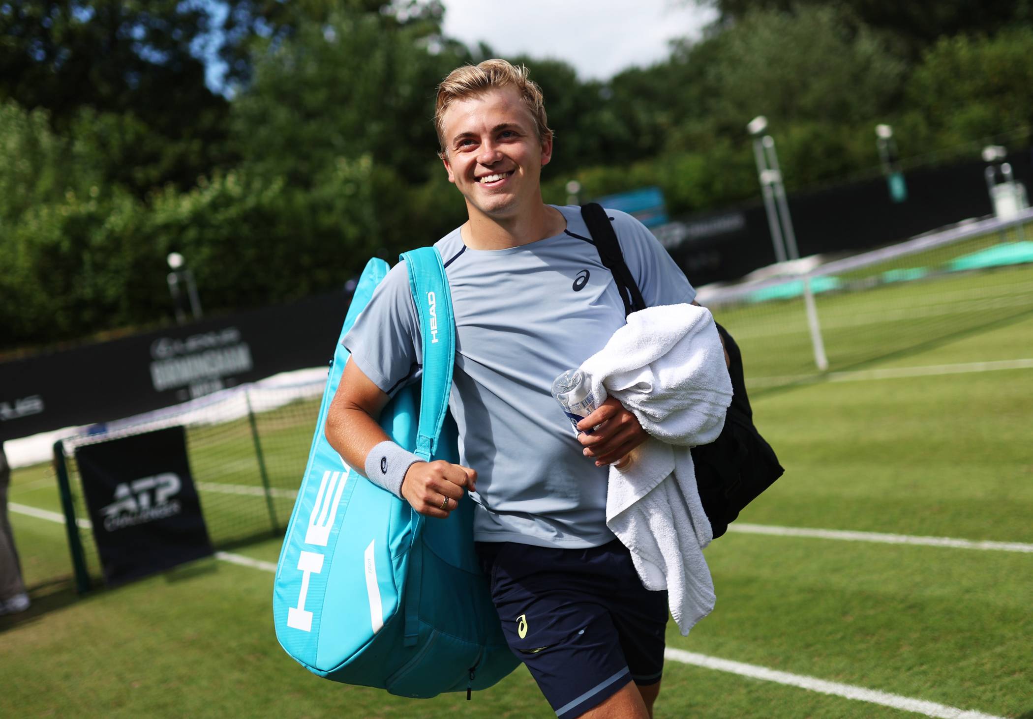 Felix Gill smiles walking off court after a win at the Lexus Birmingham Open