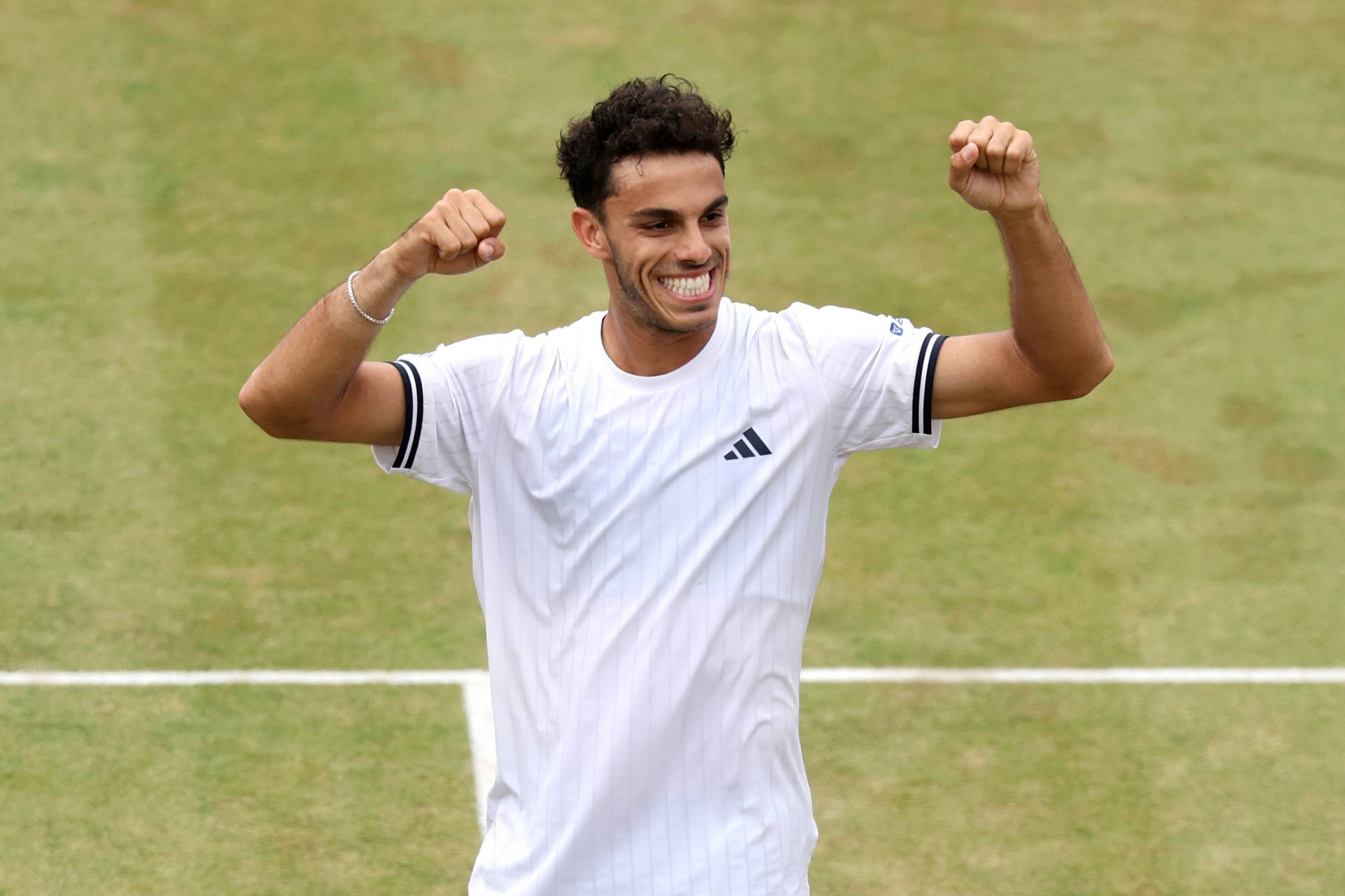 Francisco Cerundolo smiling and holding his hands up in the air on court at the HSBC Championships