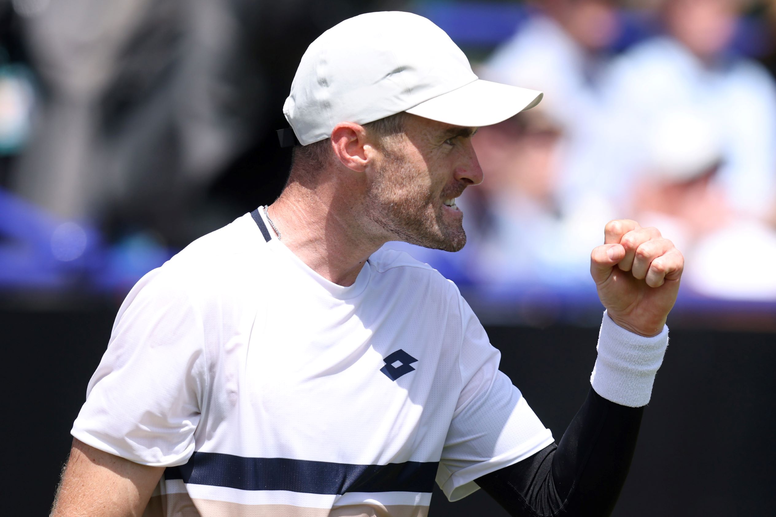Giles Hussey raising his fist to his face in celebration after winning a first round match at the Lexus Eastbourne Open