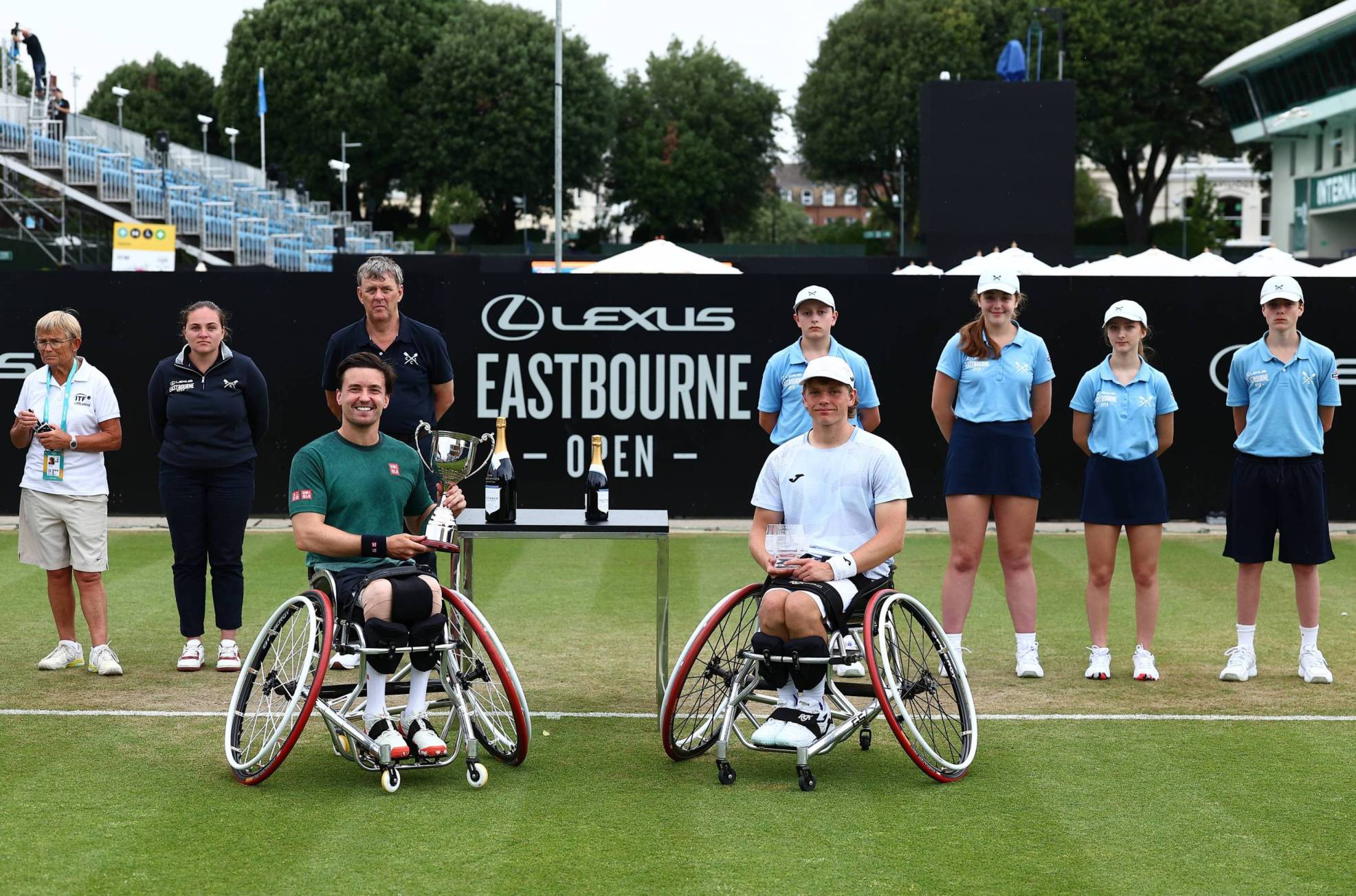 Wheelchair tennis players Gordon Reid and Ben Bartram holding their trophies on court at the Lexus Eastbourne Open