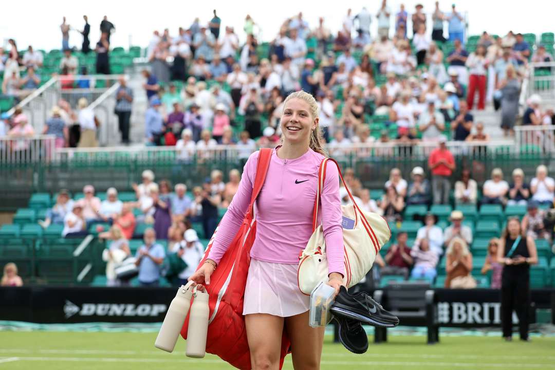 Hannah Klugman walking off court smiling with her bags at the Lexus Nottingham Open