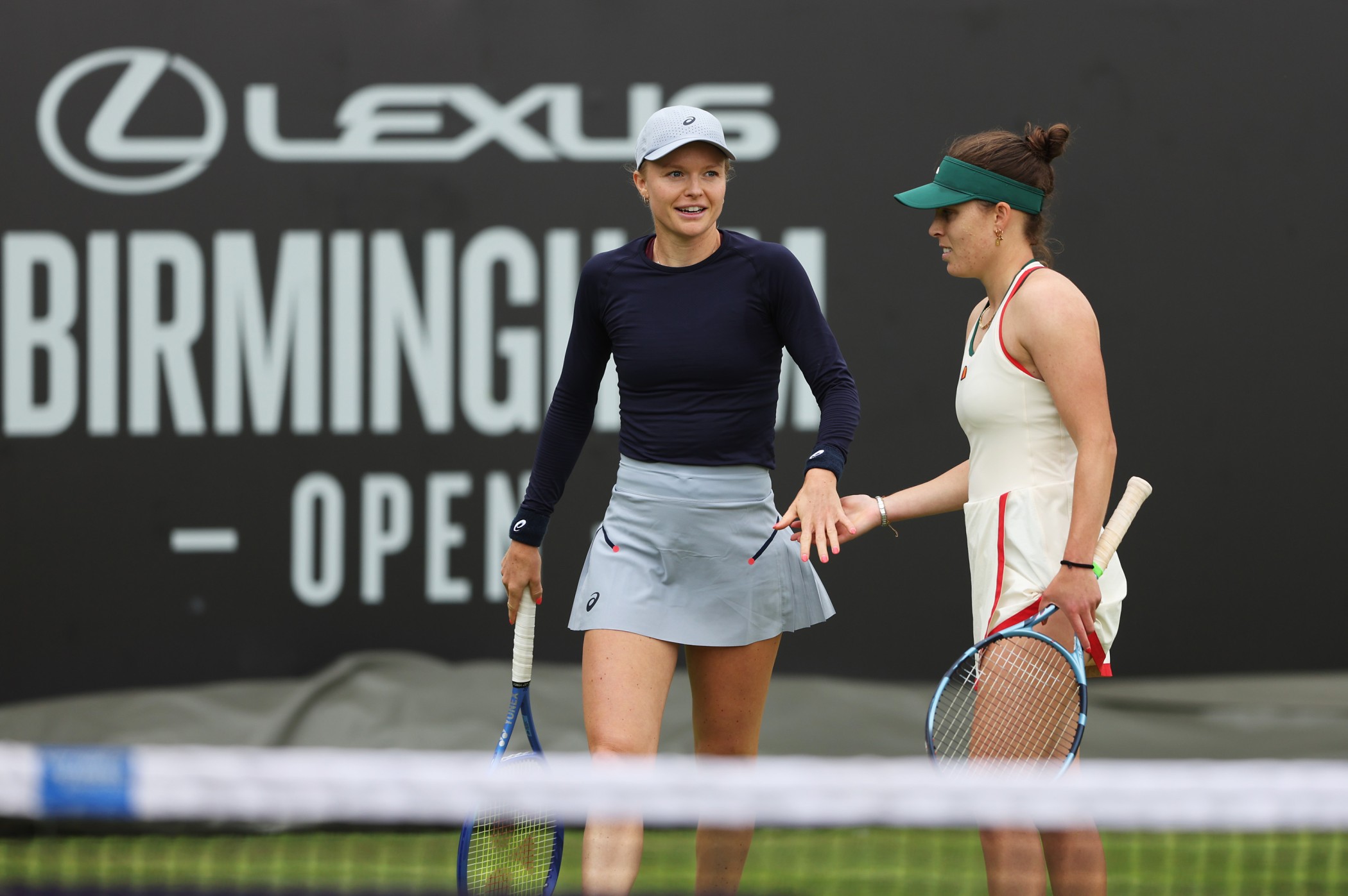 Harriet Dart and Maia Lumsden high five during a doubles match at the Lexus Birmingham Open