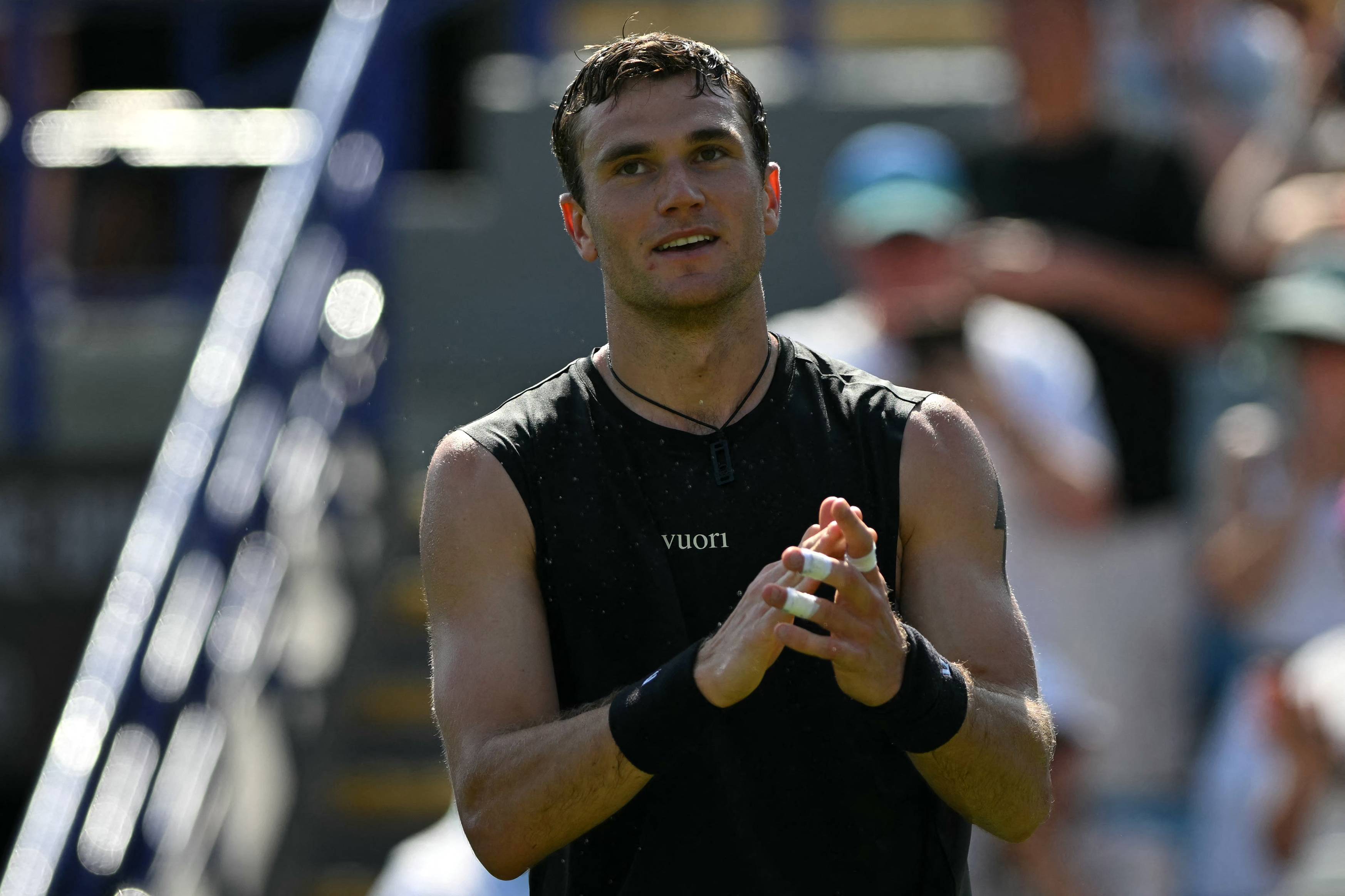 Jack Draper smiling while clapping towards the crowd on court at the Lexus Eastbourne Open