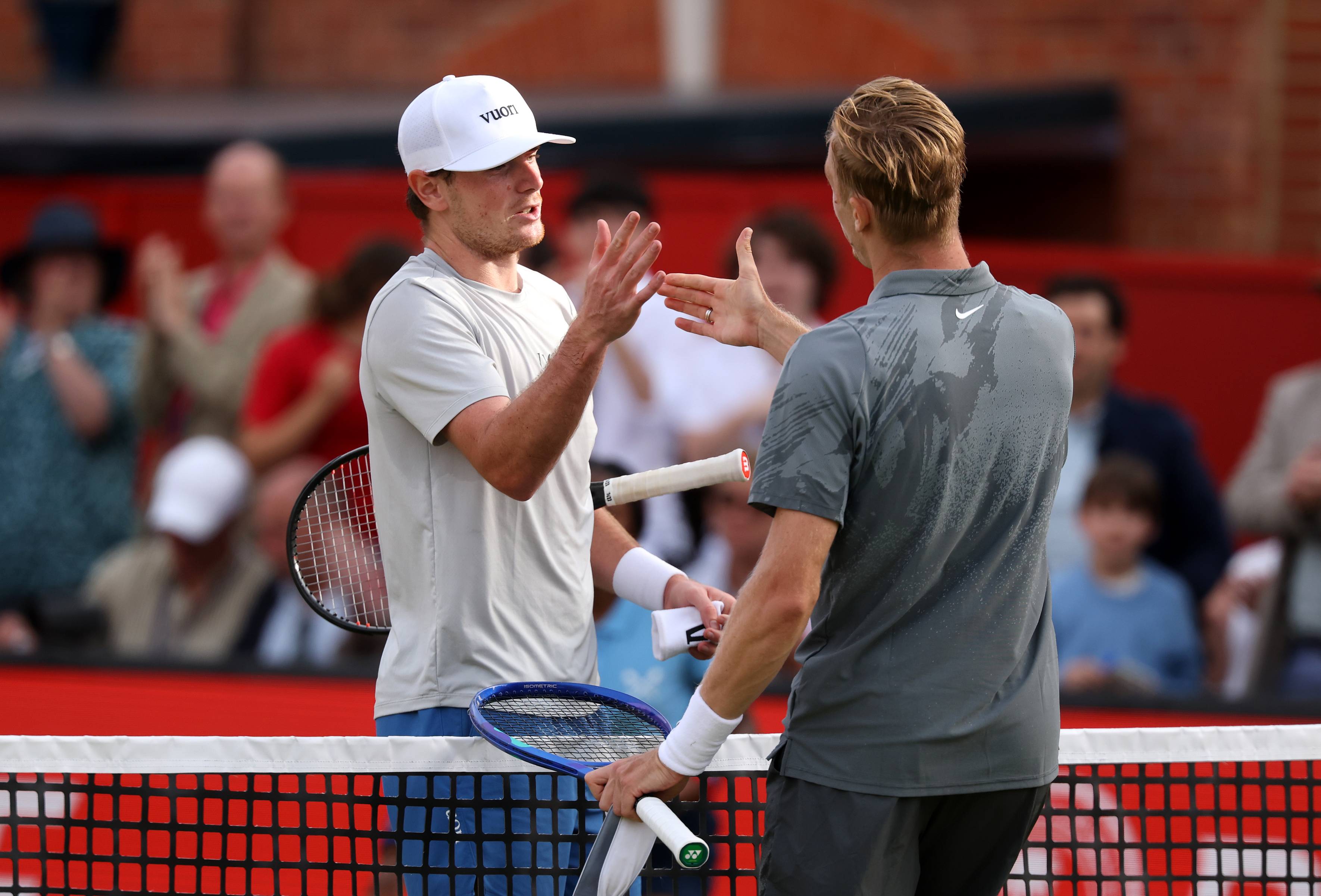 Jack Pinnington Jones shaking hands at the net with Canadian tennis player Denis Shapovalov