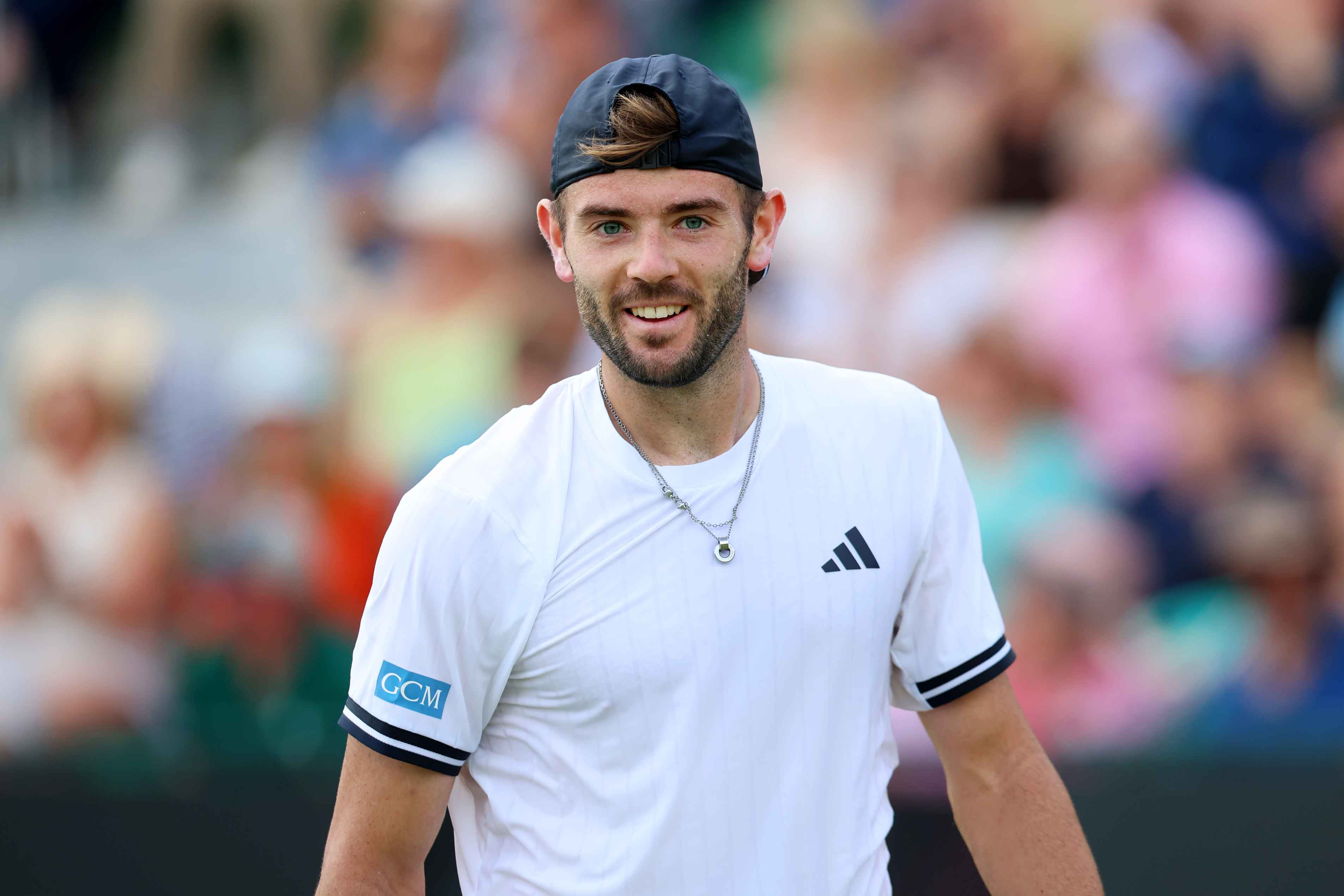 Jacob Fearnley smiling on court at the Lexus Nottingham Open