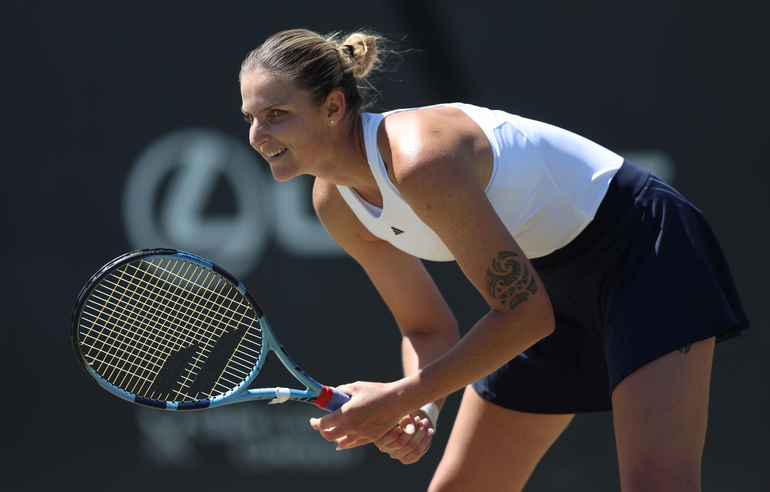 Karolina Pliskova bending down in preparation to return a serve in the quarter-final of the Lexus Nottingham Open