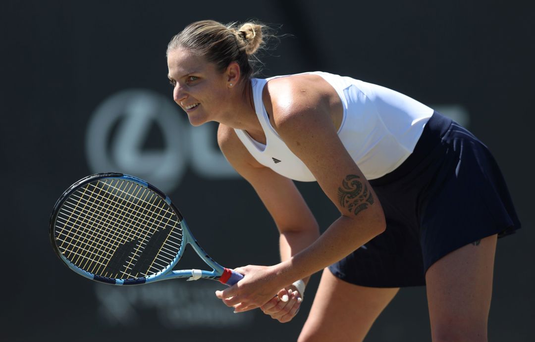 Karolina Pliskova bending down in preparation to return a serve in the quarter-final of the Lexus Nottingham Open
