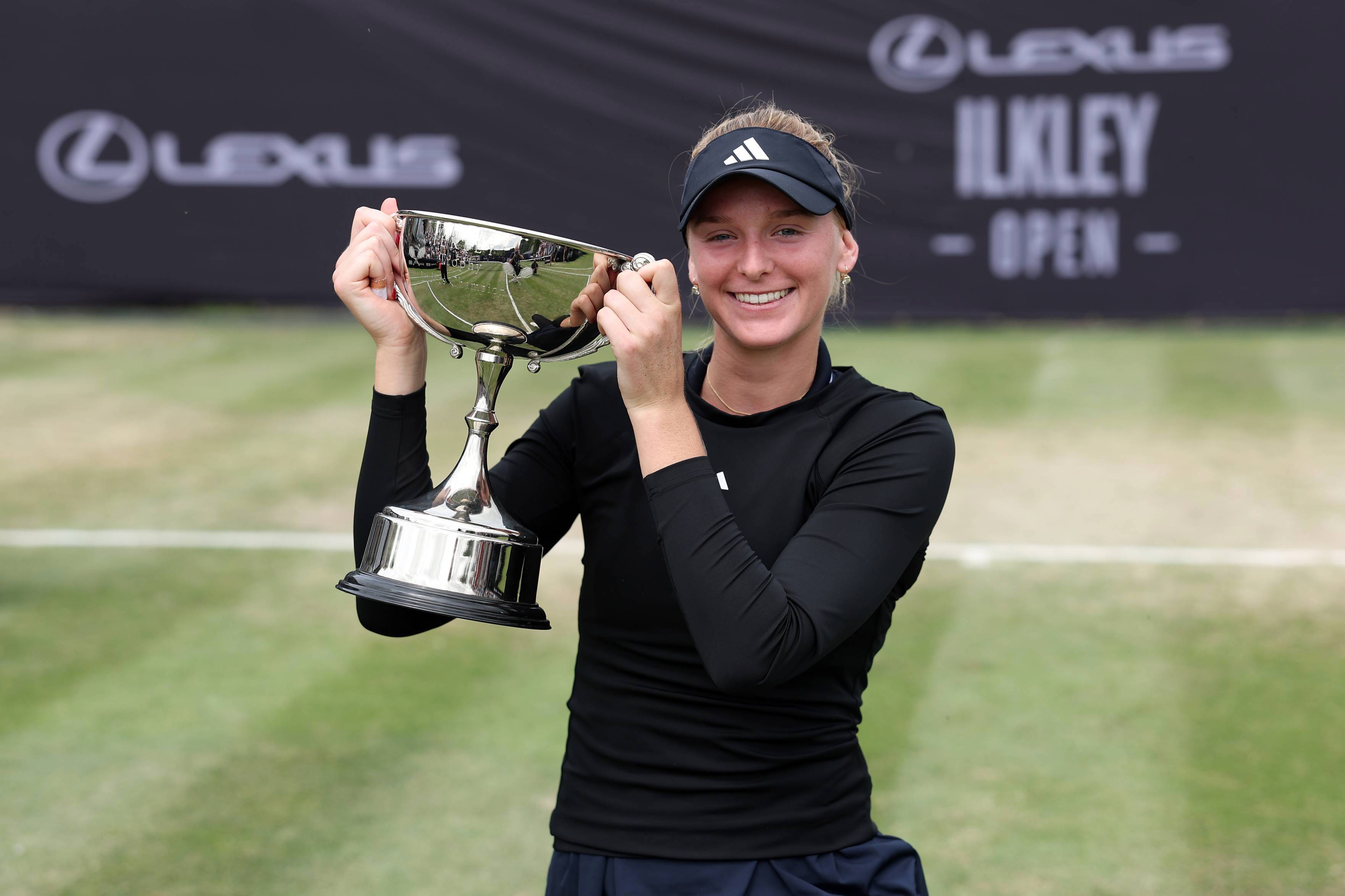 American tennis player Ashlyn Krueger holding the Lexus Ilkley Open trophy after winning the women's singles title 
