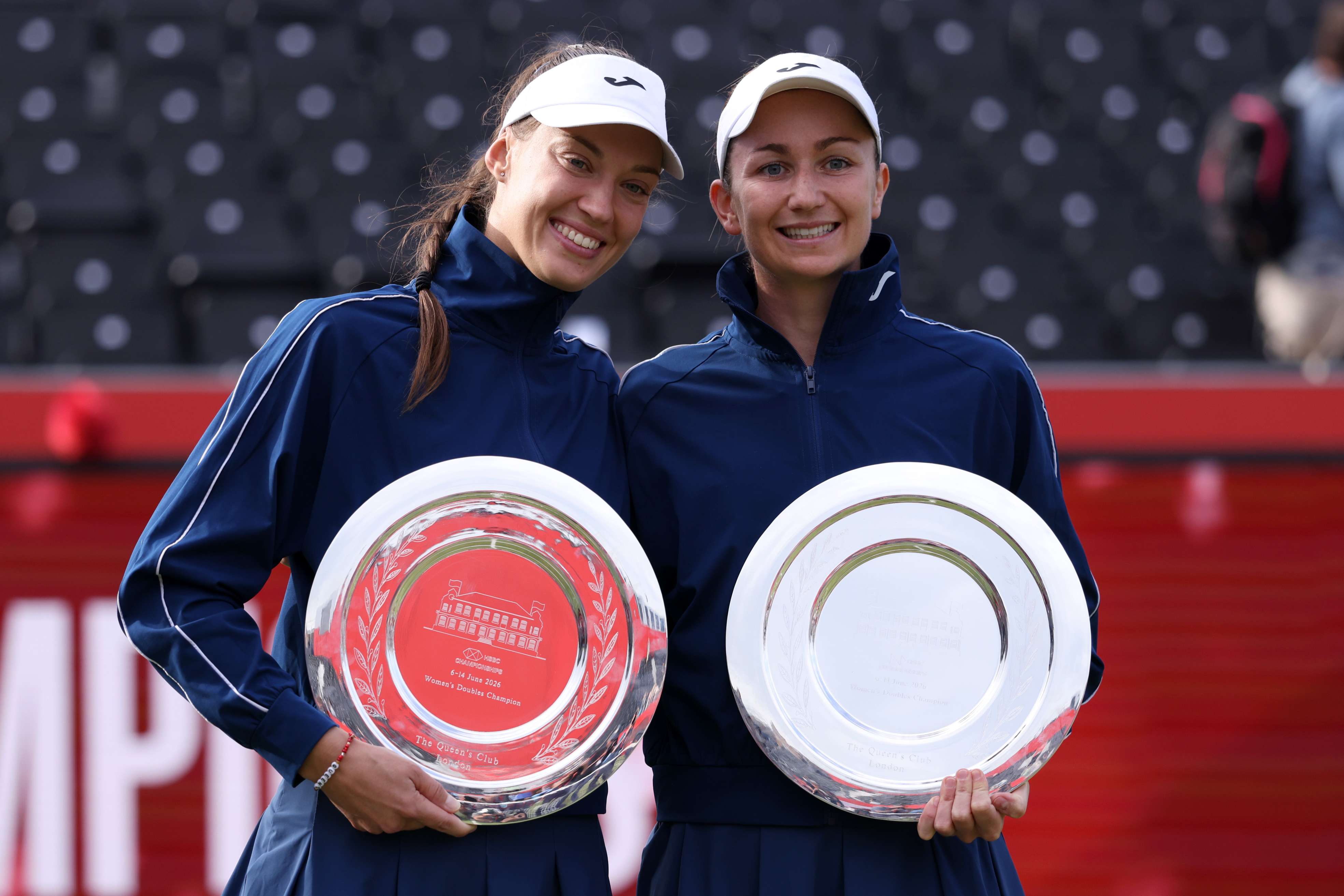 Tereza Mihalikova and Olivia Nicholls pose with the HSBC Championships women's doubles trophy