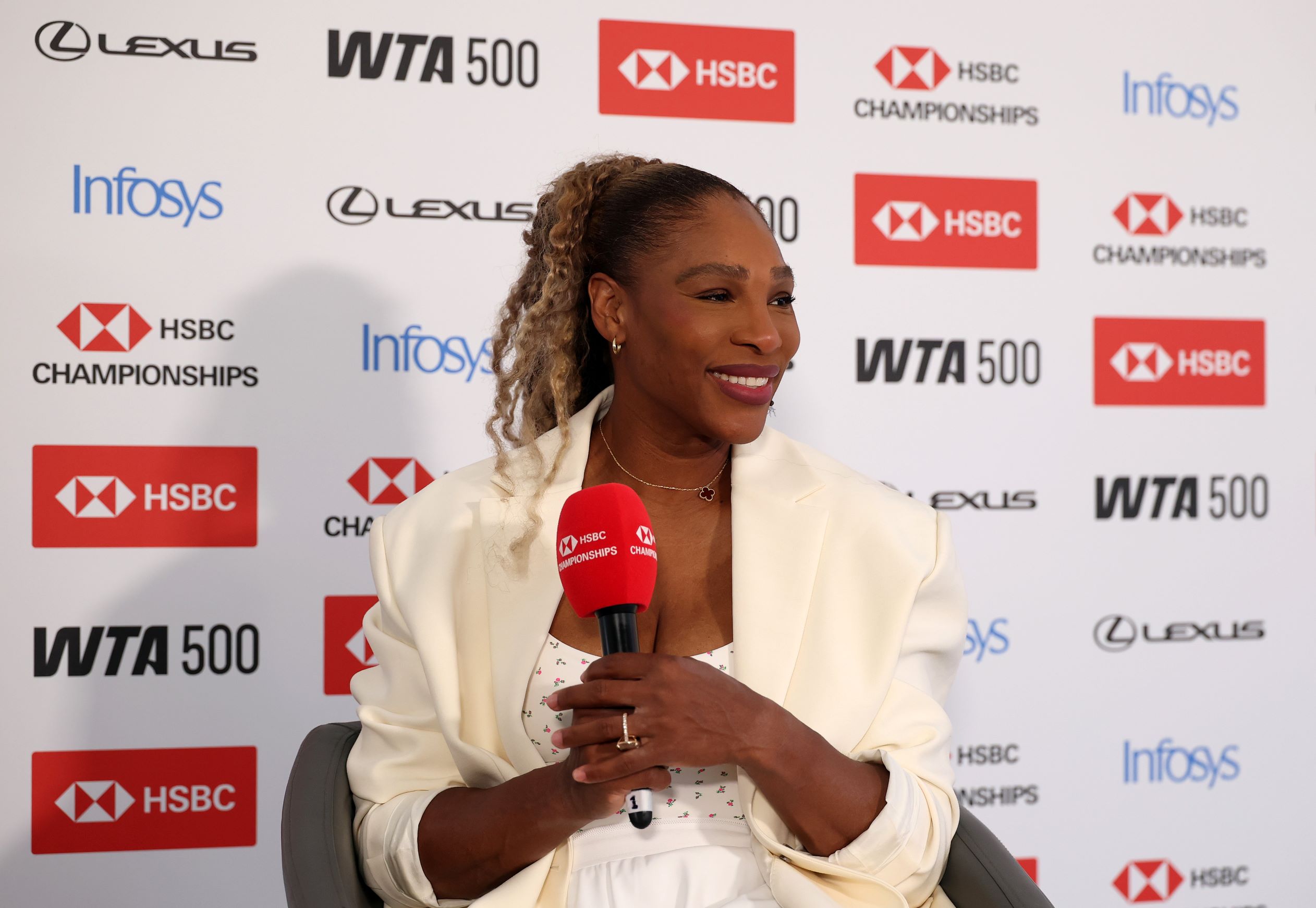 Tennis player Serena Williams holds a mic to answer questions at a press conference at the HSBC Championships