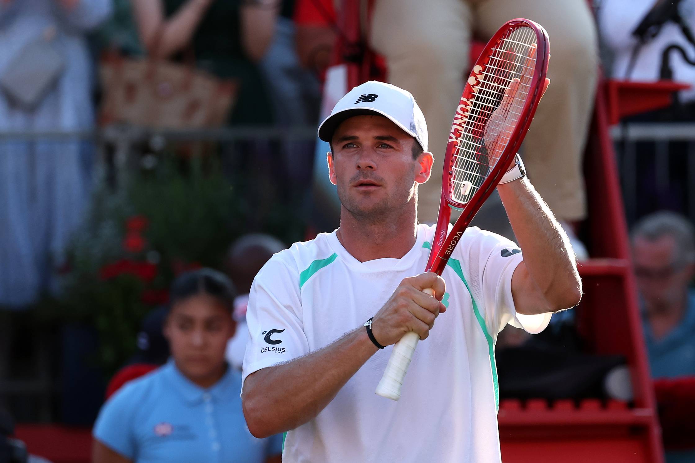 Tommy Paul clapping his tennis racket while addressing the crowd on court at the HSBC Championships