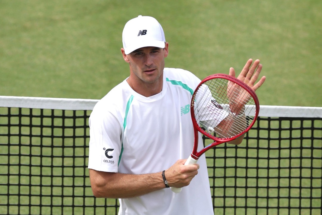 Tommy Paul clapping his tennis racket on court at the HSBC Championships
