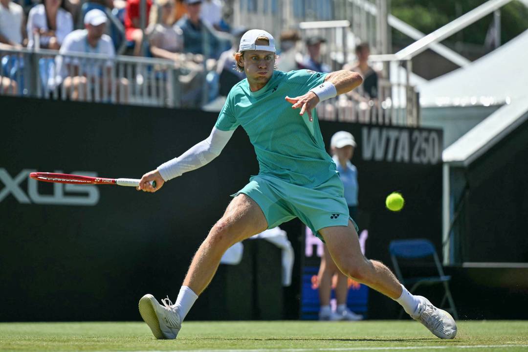 Zizou Bergs stretching to hit a forehand on court at the Lexus Eastbourne Open