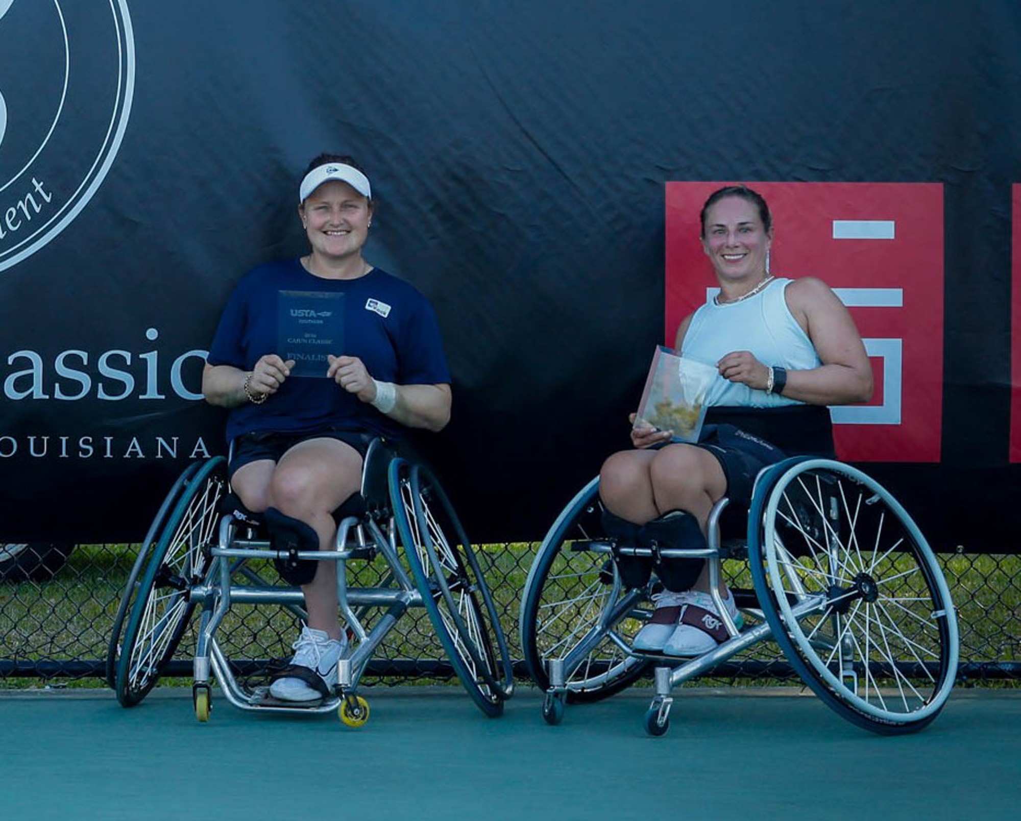 Aniek Van Koot and Lucy Shuker holding trophies at the Cajun Classic