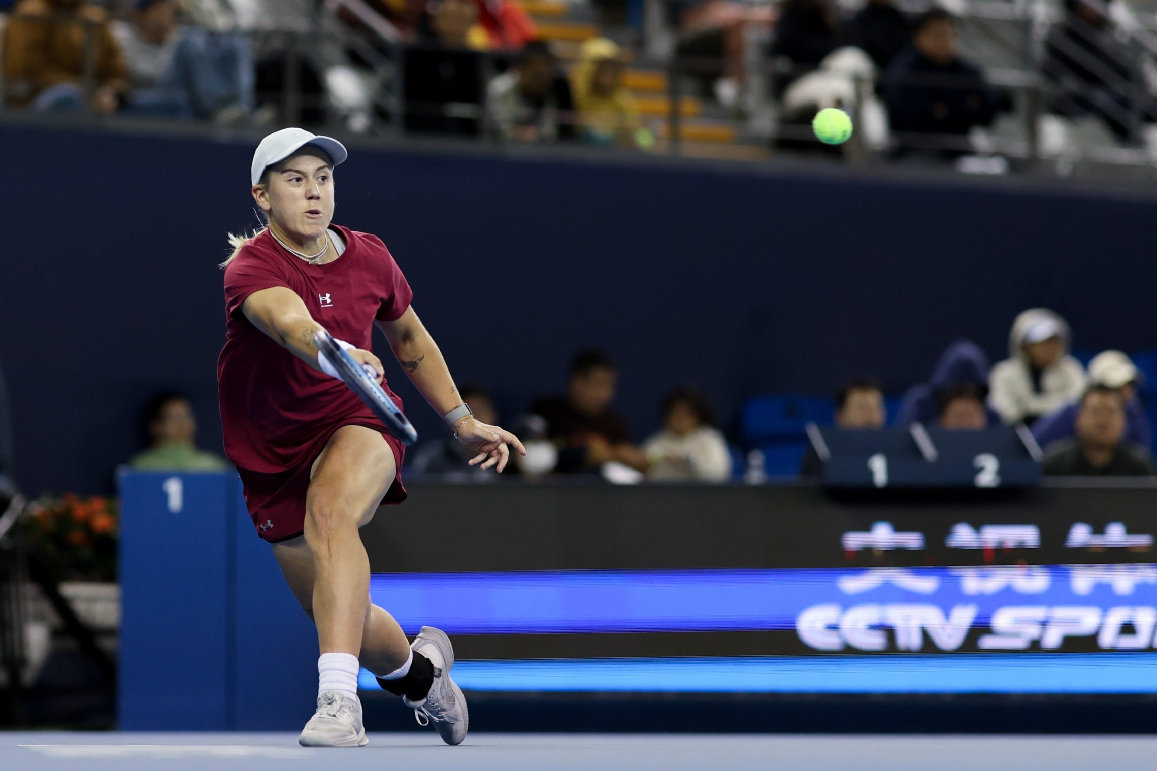 British tennis player Sonay Kartal stretcing forward to return a tennis ball on court at the China Open